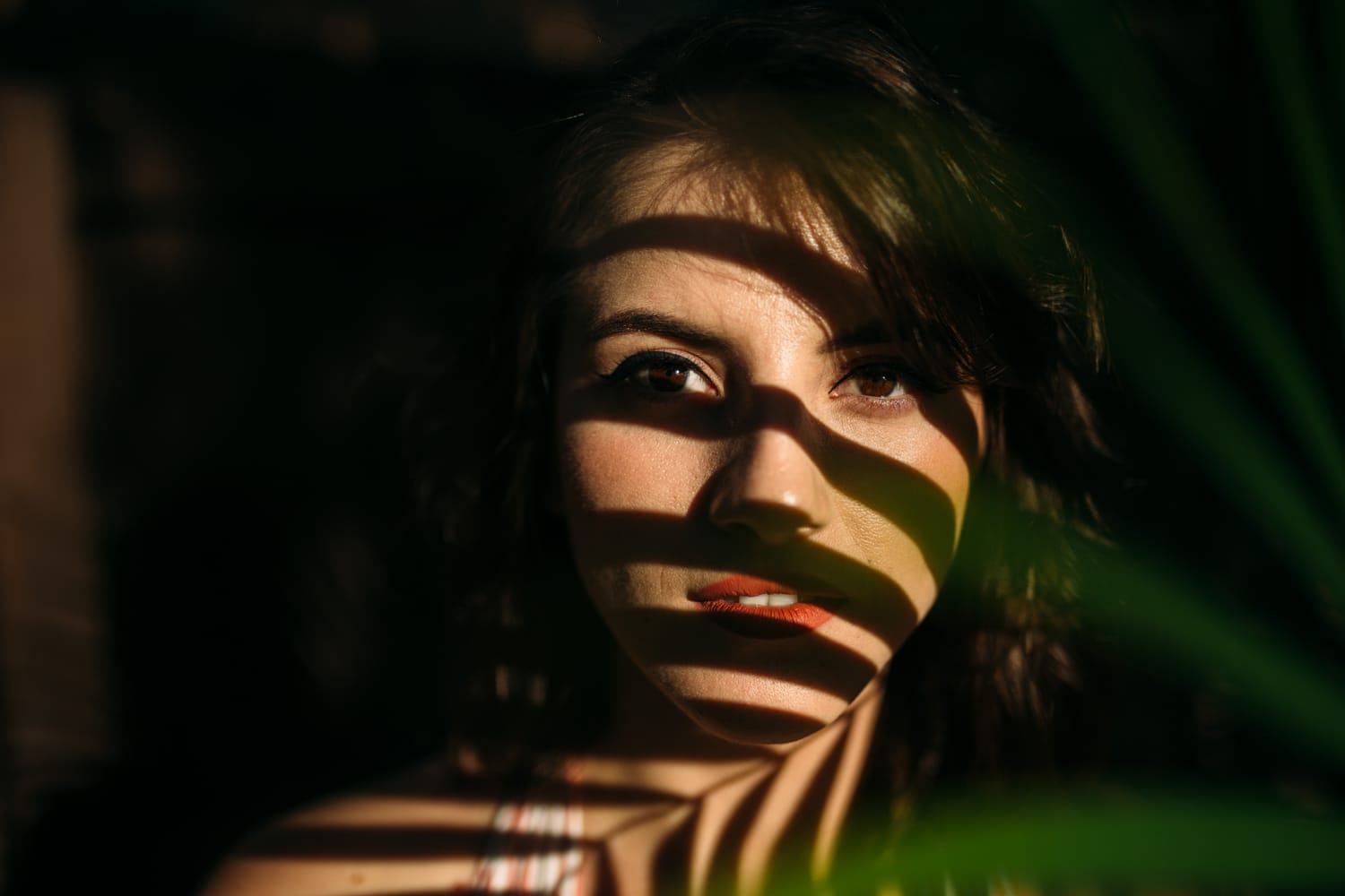 Mariia in Miami portraits story frame 1: Miami portraits for Mariia with hard palm-shadow light, pale dress, sunglasses and a bright coastal-city feel.