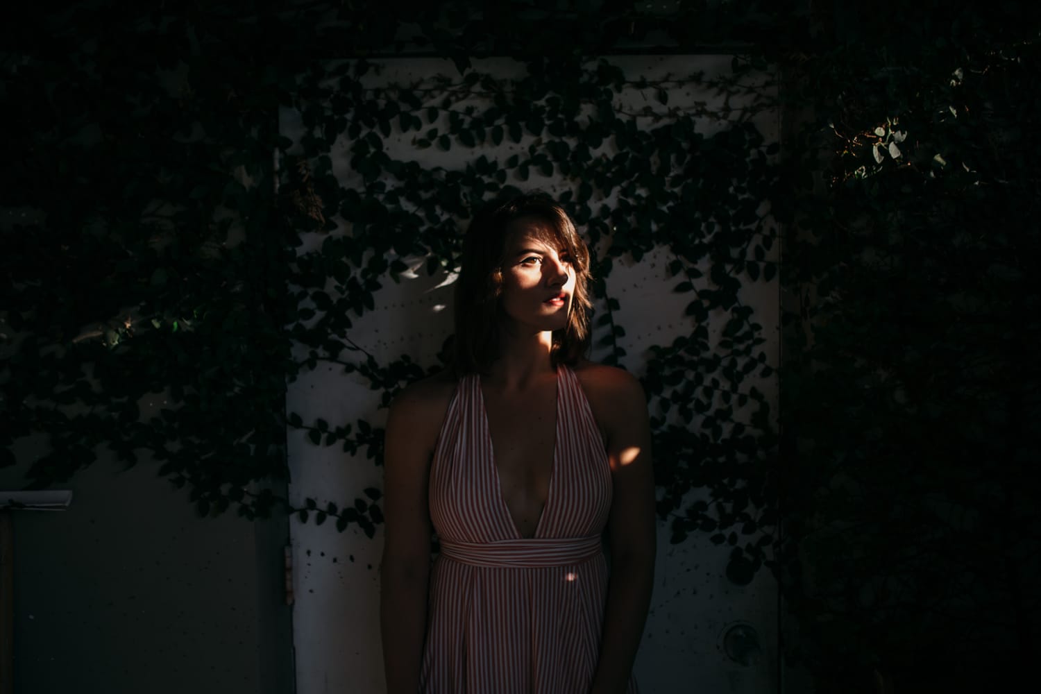 Mariia in Miami portraits story frame 2: Miami portraits for Mariia with hard palm-shadow light, pale dress, sunglasses and a bright coastal-city feel.