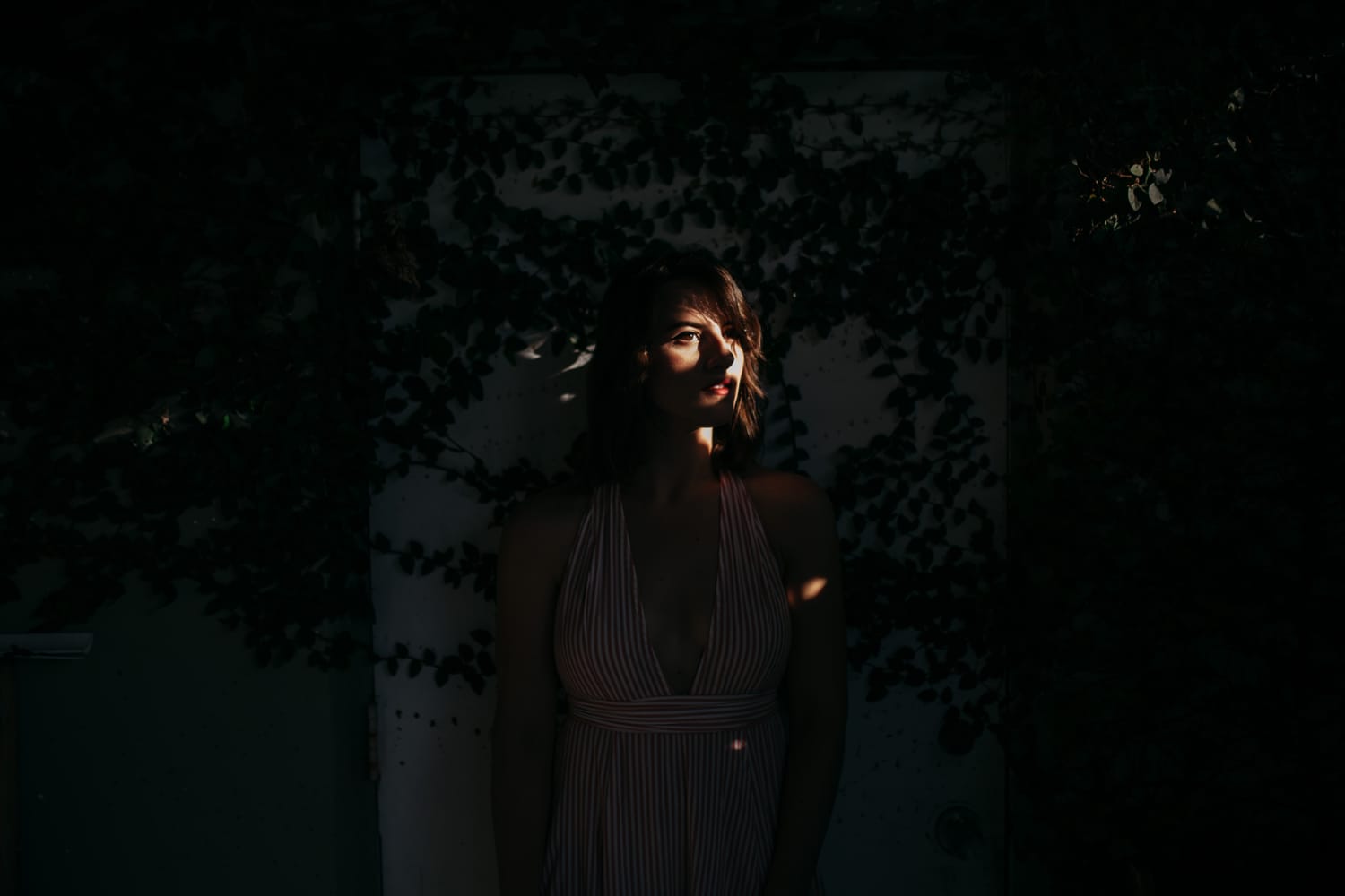 Mariia in Miami portraits story frame 3: Miami portraits for Mariia with hard palm-shadow light, pale dress, sunglasses and a bright coastal-city feel.