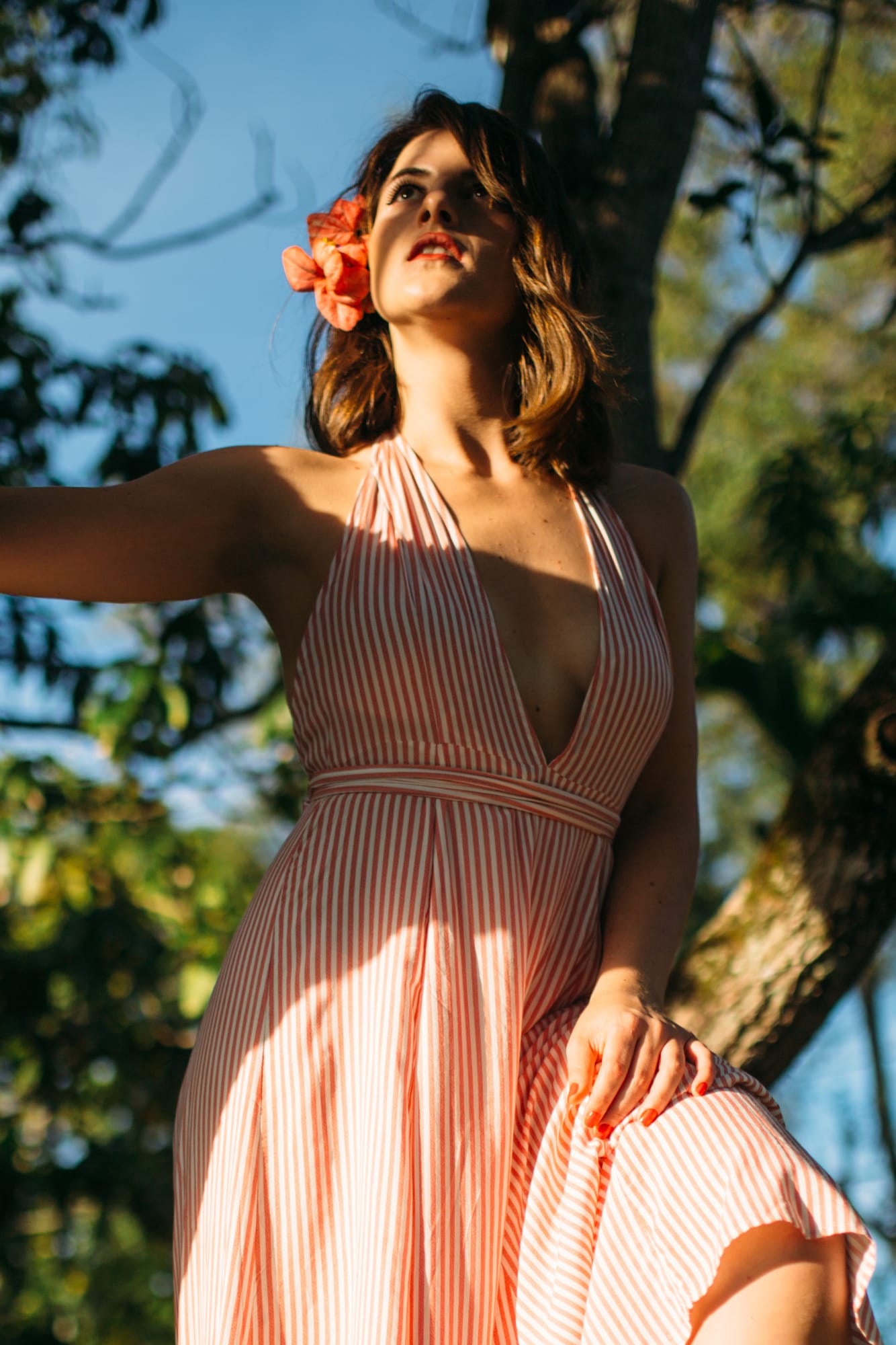 Mariia in Miami portraits story frame 4: Miami portraits for Mariia with hard palm-shadow light, pale dress, sunglasses and a bright coastal-city feel.