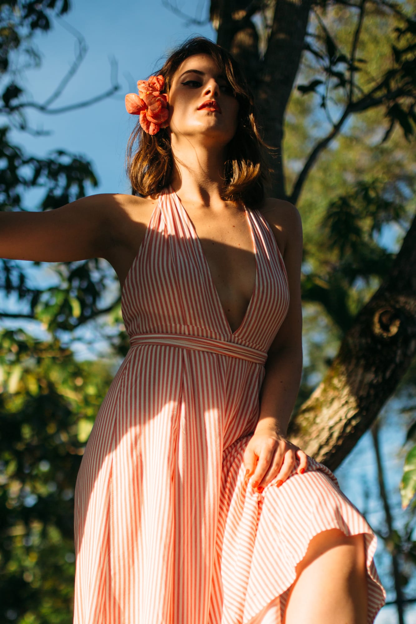 Mariia in Miami portraits story frame 5: Miami portraits for Mariia with hard palm-shadow light, pale dress, sunglasses and a bright coastal-city feel.