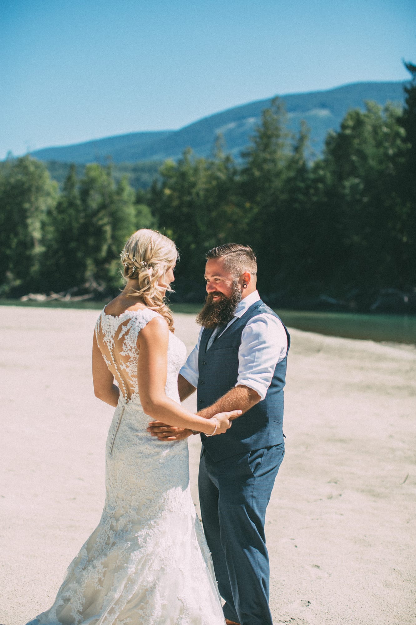 Megan and Jarid weddings story frame 6: A Shuswap-area wedding around Sicamous, Swansea Point and Hyde Mountain, with boat/lake context, cliff portraits and strong floral colour..