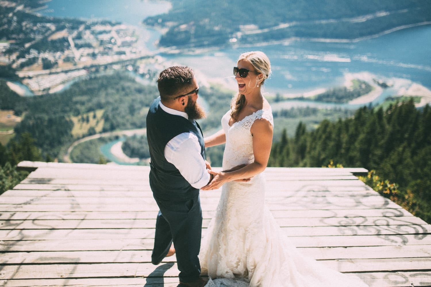 Megan and Jarid weddings story frame 10: A Shuswap-area wedding around Sicamous, Swansea Point and Hyde Mountain, with boat/lake context, cliff portraits and strong floral colour..