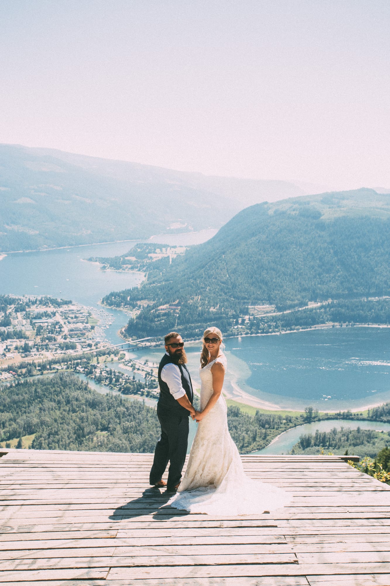 Megan and Jarid weddings story frame 12: A Shuswap-area wedding around Sicamous, Swansea Point and Hyde Mountain, with boat/lake context, cliff portraits and strong floral colour..