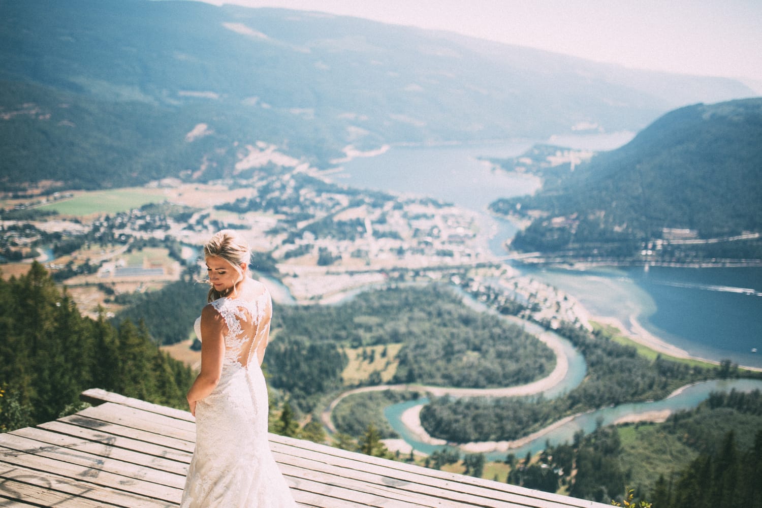 Megan and Jarid weddings story frame 13: A Shuswap-area wedding around Sicamous, Swansea Point and Hyde Mountain, with boat/lake context, cliff portraits and strong floral colour..