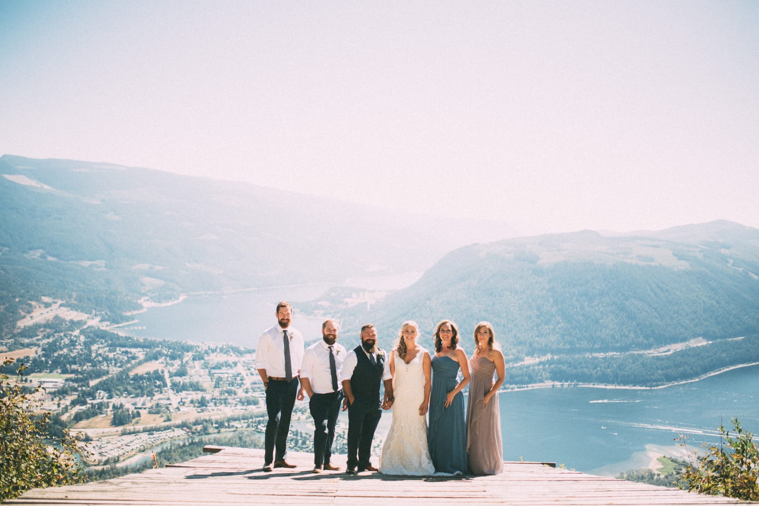 Megan and Jarid weddings story frame 14: A Shuswap-area wedding around Sicamous, Swansea Point and Hyde Mountain, with boat/lake context, cliff portraits and strong floral colour..