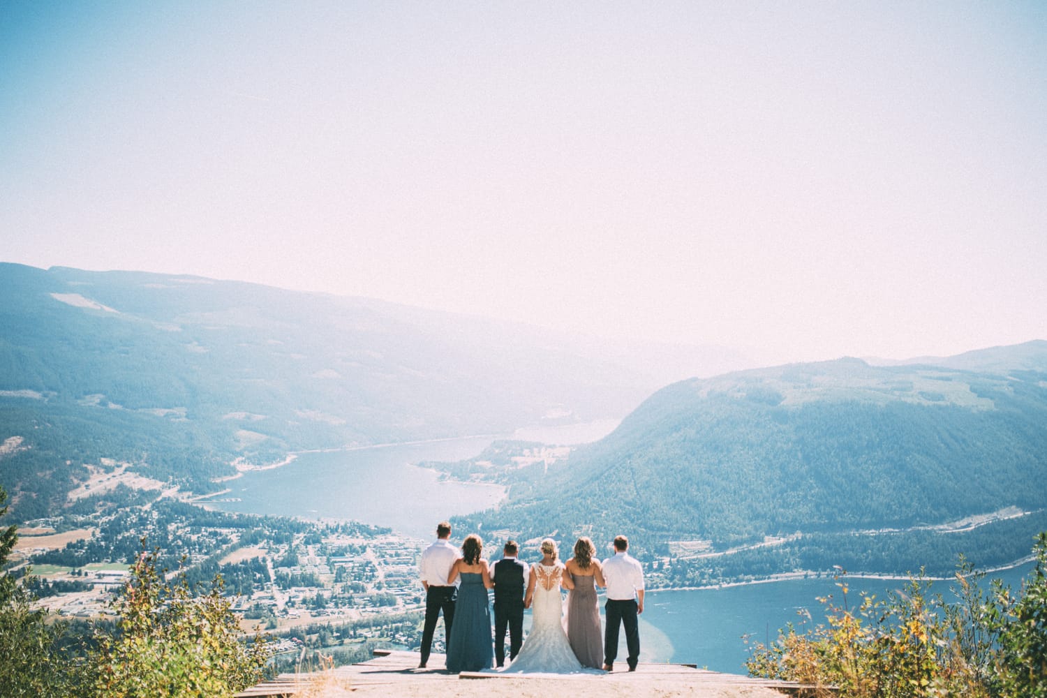 Megan and Jarid weddings story frame 15: A Shuswap-area wedding around Sicamous, Swansea Point and Hyde Mountain, with boat/lake context, cliff portraits and strong floral colour..