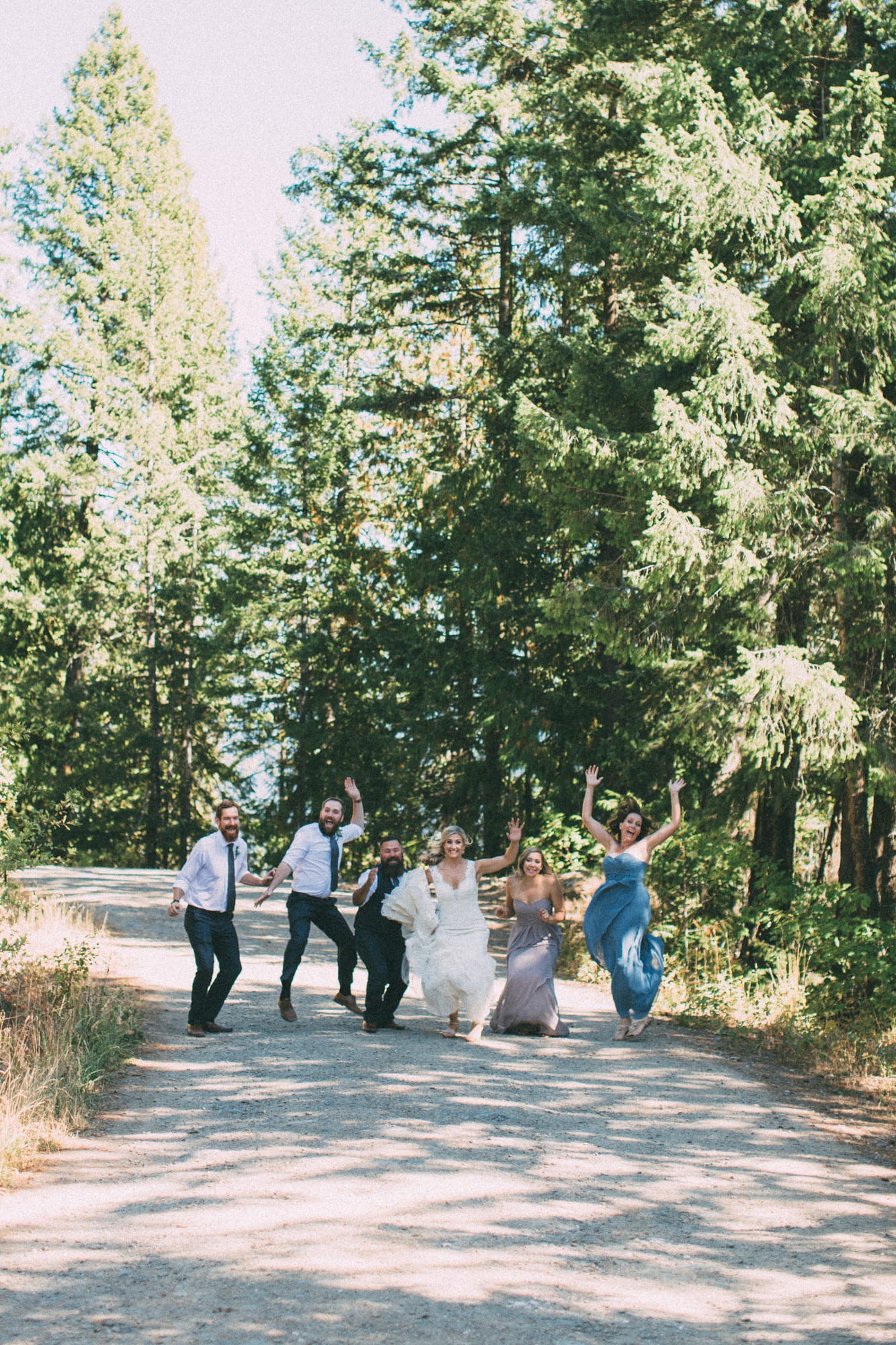 Megan and Jarid weddings story frame 16: A Shuswap-area wedding around Sicamous, Swansea Point and Hyde Mountain, with boat/lake context, cliff portraits and strong floral colour..