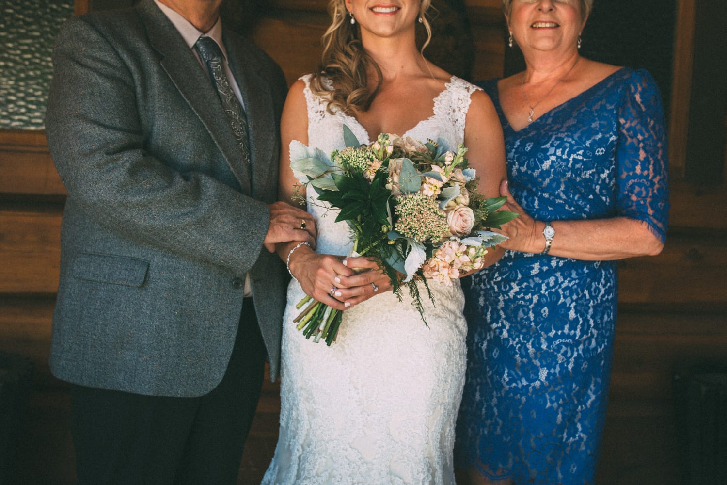 Megan and Jarid weddings story frame 18: A Shuswap-area wedding around Sicamous, Swansea Point and Hyde Mountain, with boat/lake context, cliff portraits and strong floral colour..
