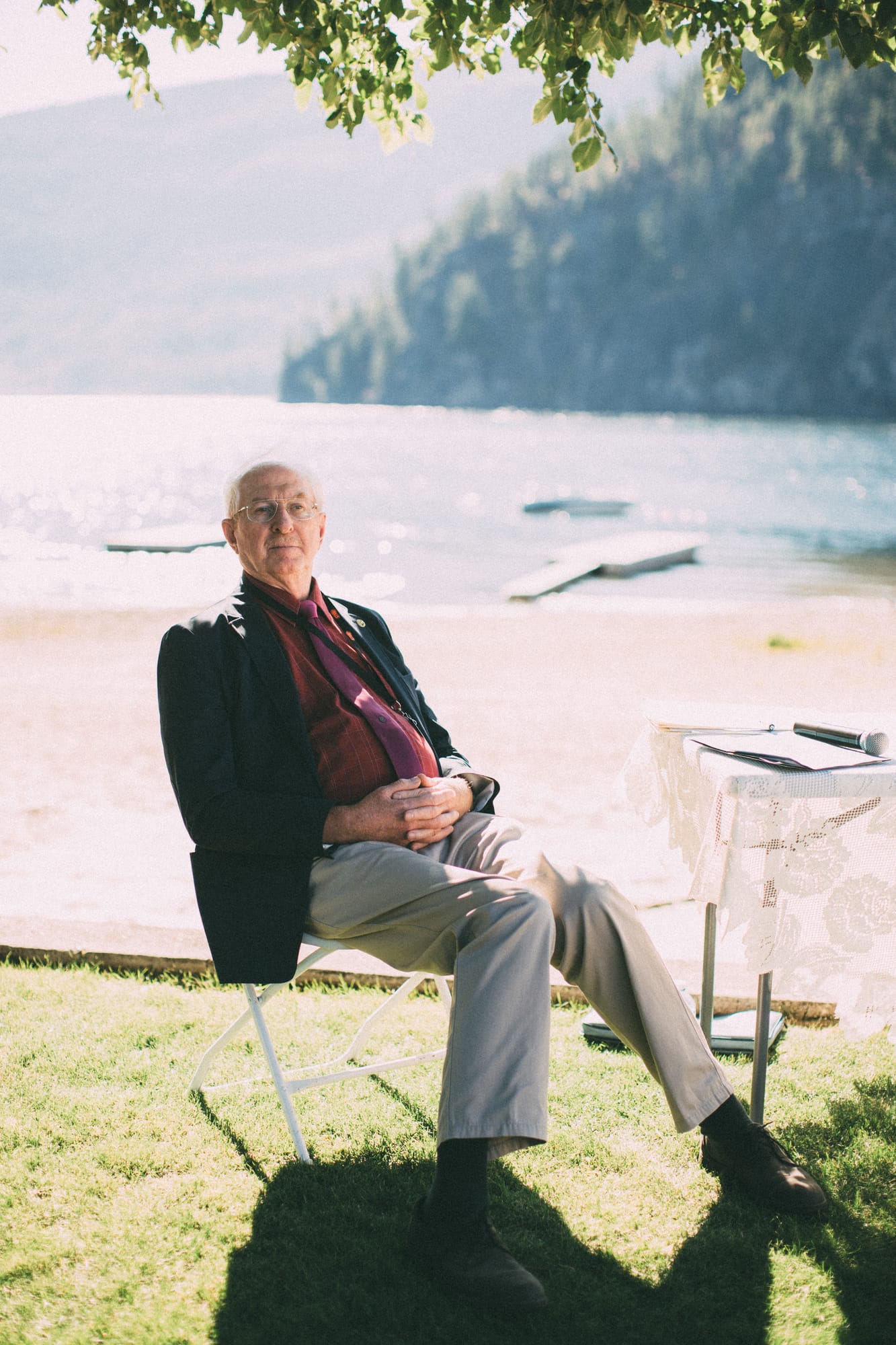 Megan and Jarid weddings story frame 20: A Shuswap-area wedding around Sicamous, Swansea Point and Hyde Mountain, with boat/lake context, cliff portraits and strong floral colour..