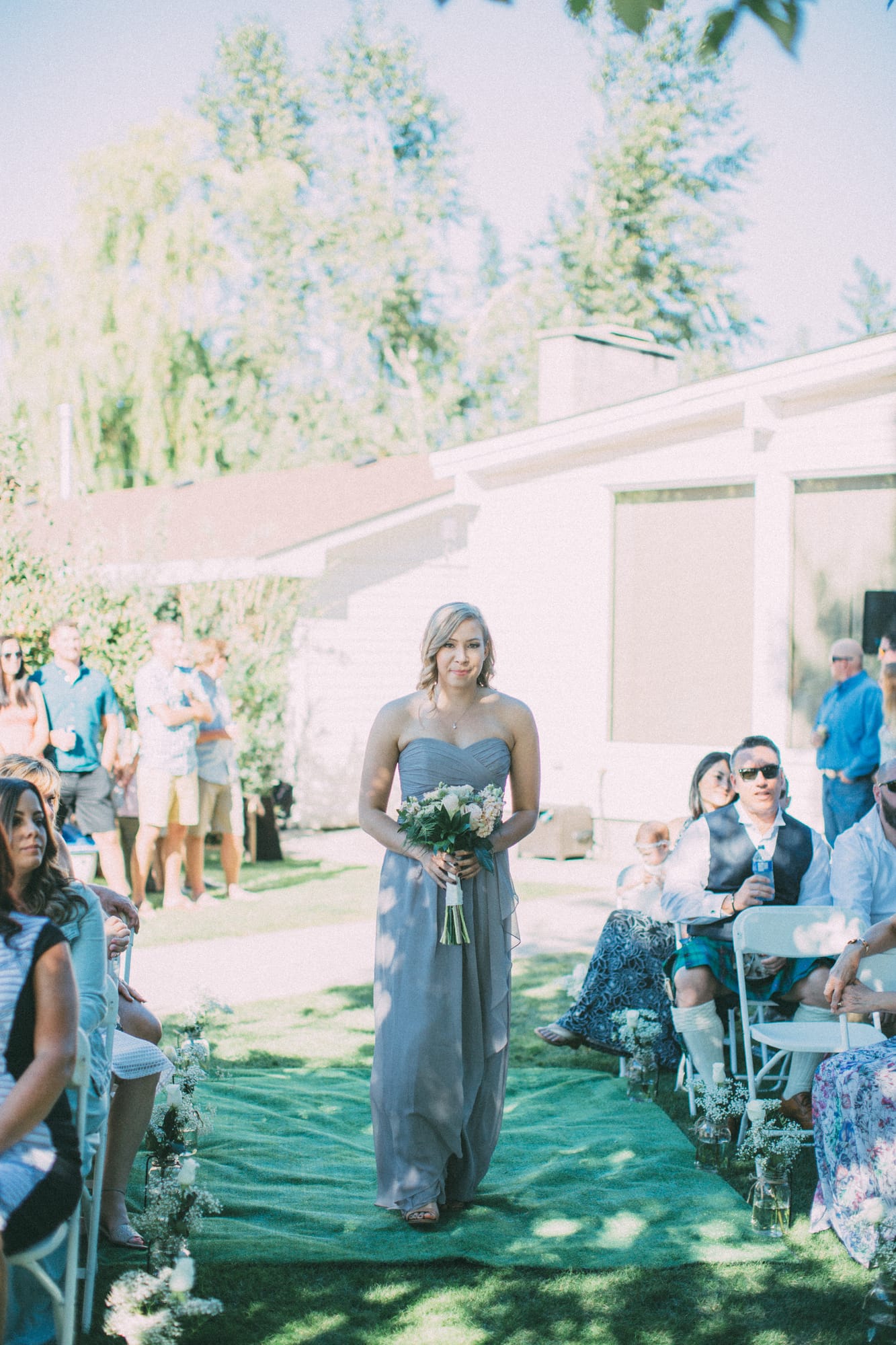 Megan and Jarid weddings story frame 22: A Shuswap-area wedding around Sicamous, Swansea Point and Hyde Mountain, with boat/lake context, cliff portraits and strong floral colour..
