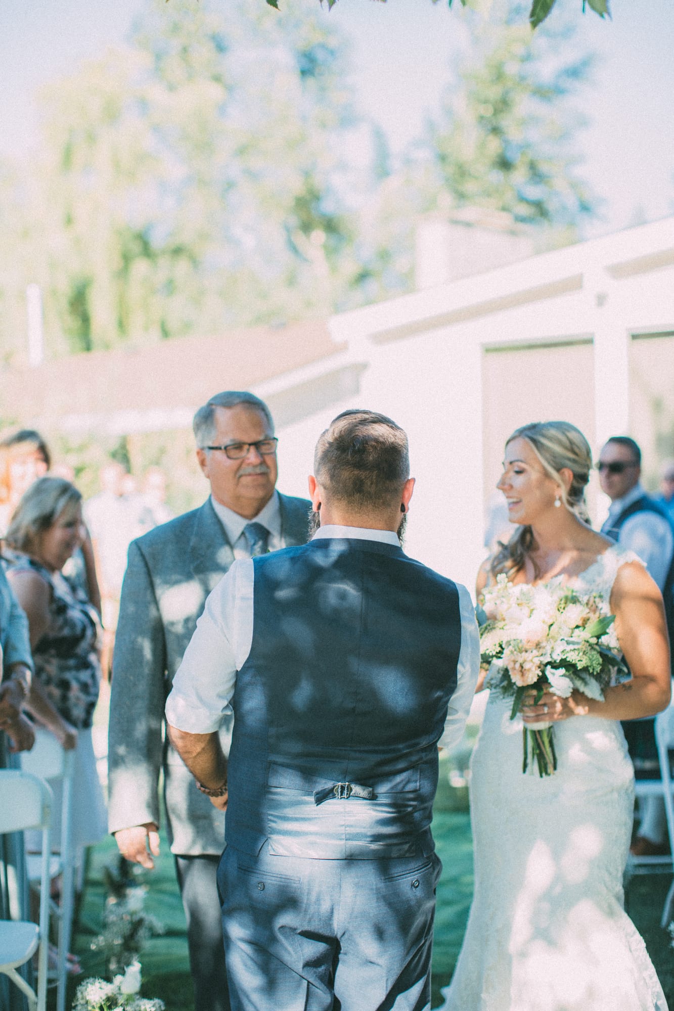 Megan and Jarid weddings story frame 23: A Shuswap-area wedding around Sicamous, Swansea Point and Hyde Mountain, with boat/lake context, cliff portraits and strong floral colour..