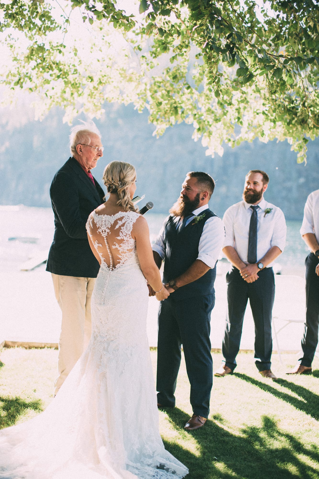 Megan and Jarid weddings story frame 24: A Shuswap-area wedding around Sicamous, Swansea Point and Hyde Mountain, with boat/lake context, cliff portraits and strong floral colour..