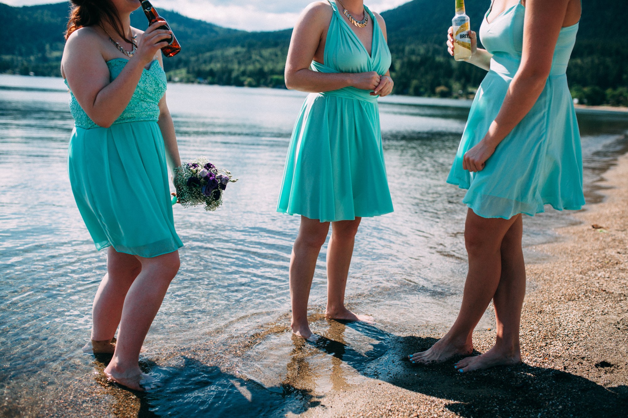 Mel & Eric: Bridesmaids standing barefoot at the waterline.
