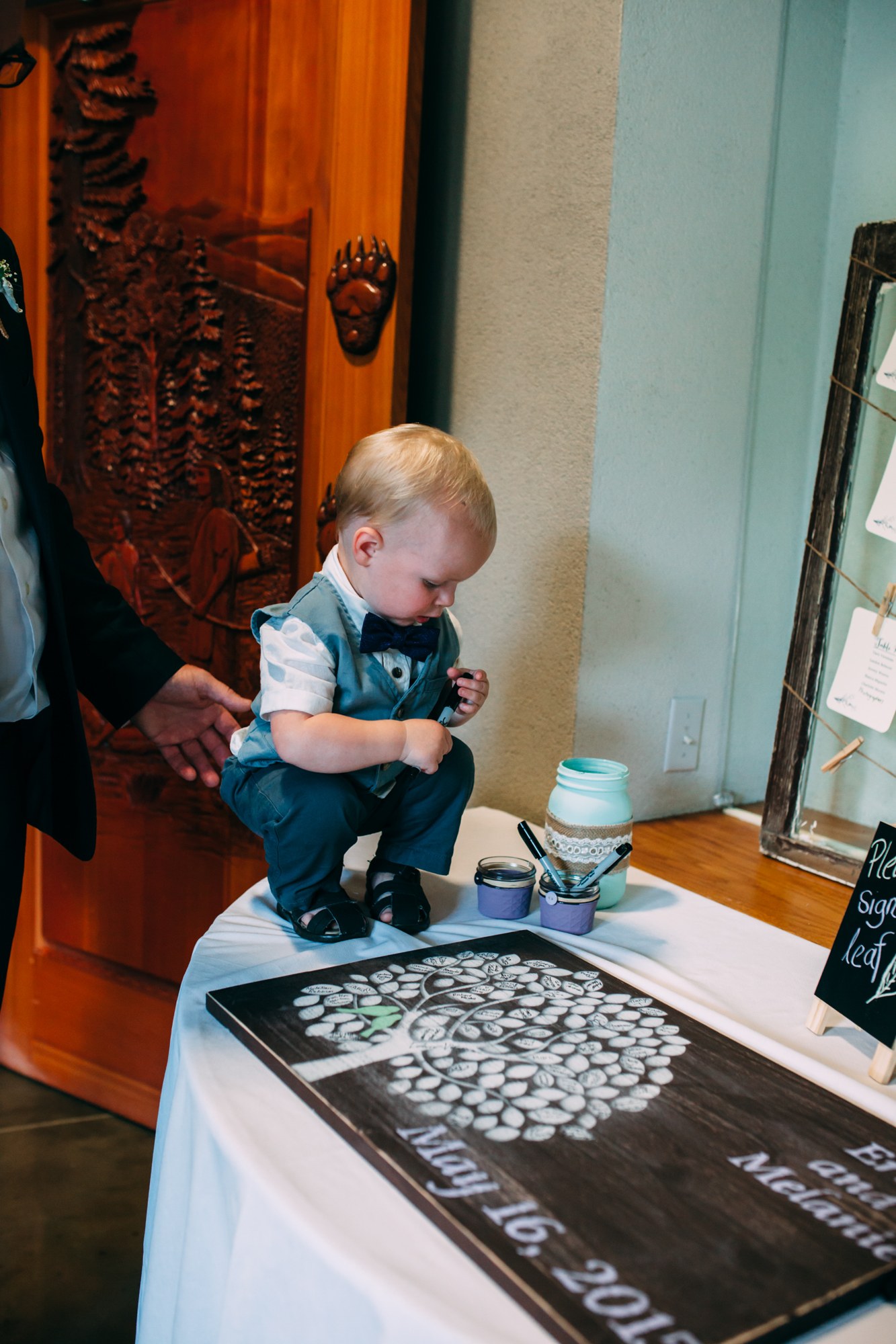 Mel & Eric: A young guest adding to the wedding guestbook.