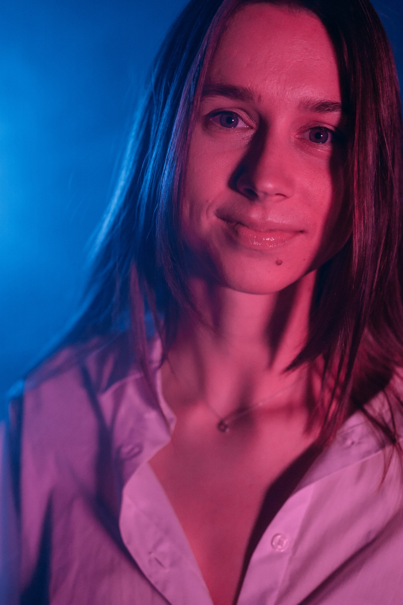 Our Yoga Space Studio Portraits: Gentle smile in pink and blue light.