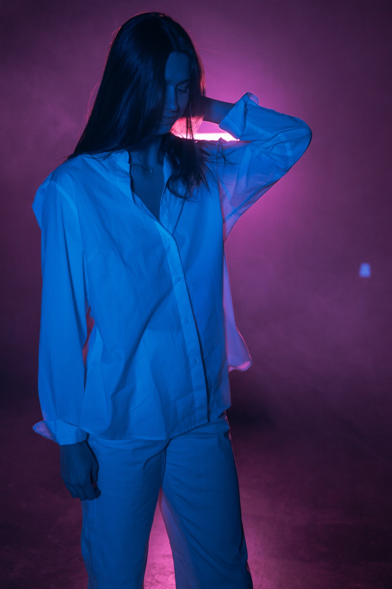 Our Yoga Space Studio Portraits: Graphic blue-lit full figure and raised hand.