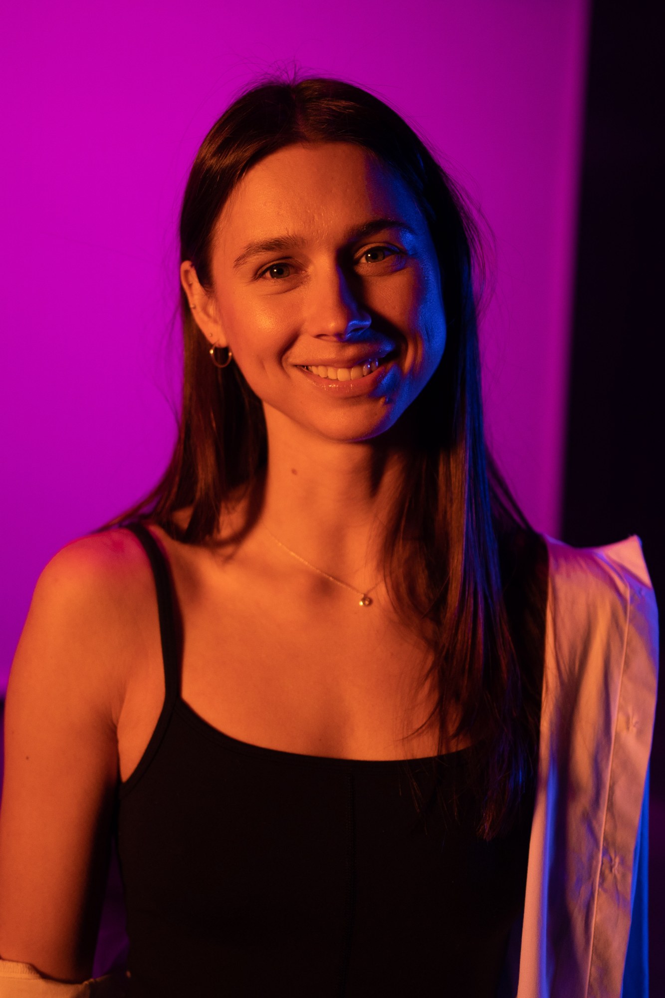 Our Yoga Space Studio Portraits: Warm smile against the pink backdrop.