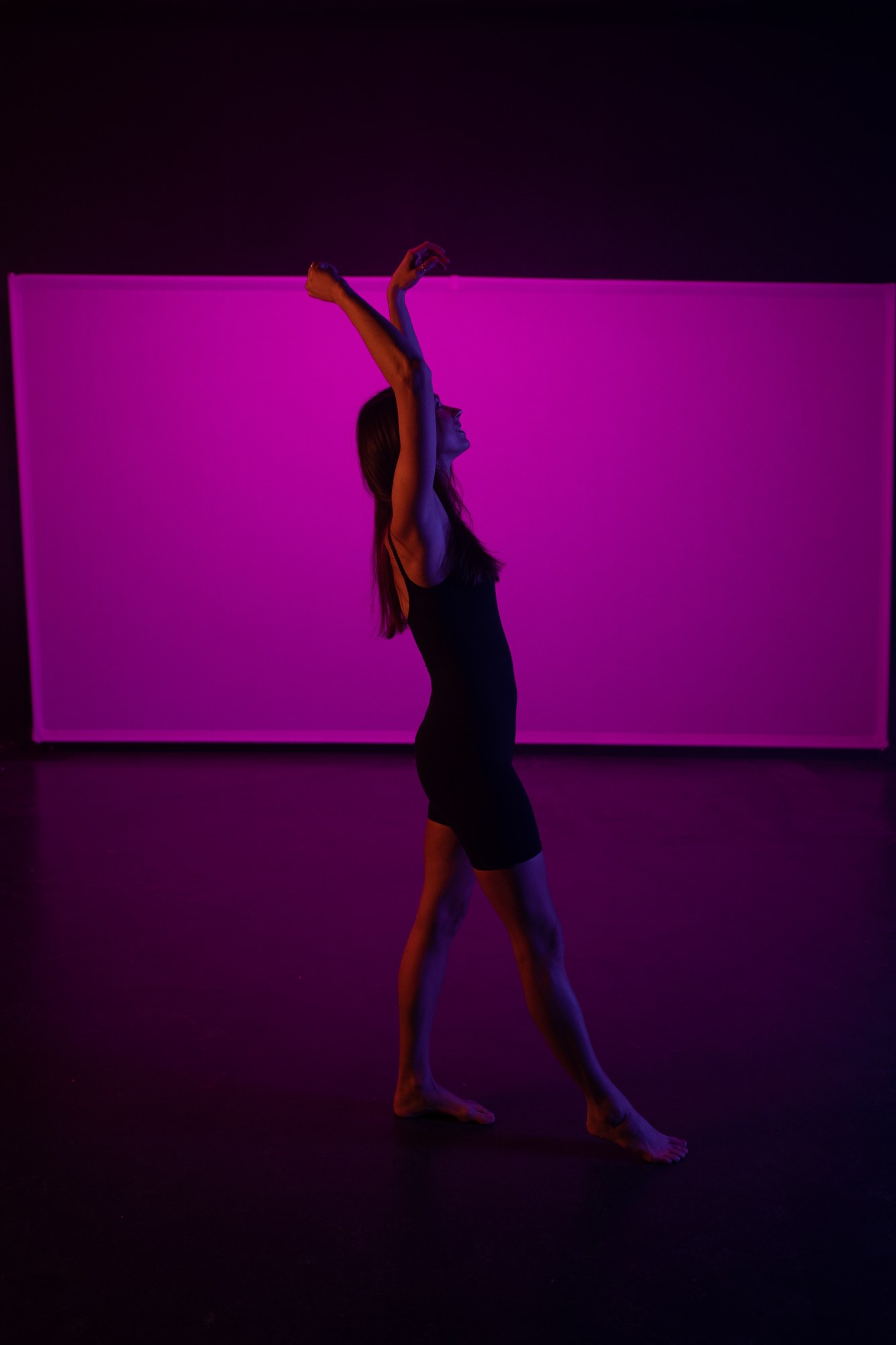 Our Yoga Space Studio Portraits: Long reaching silhouette against the pink set.