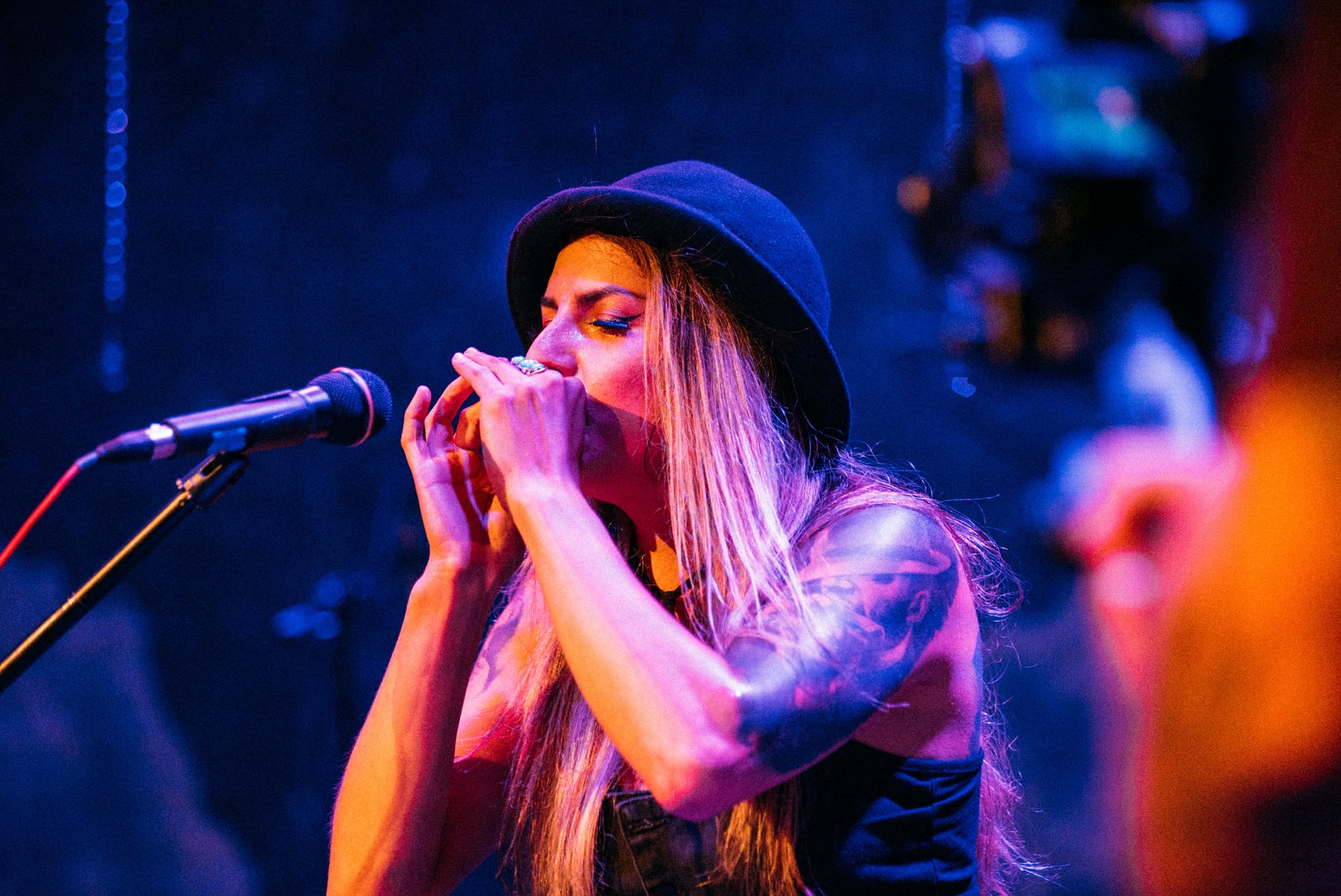 Close horizontal view of a performer singing into the microphone.