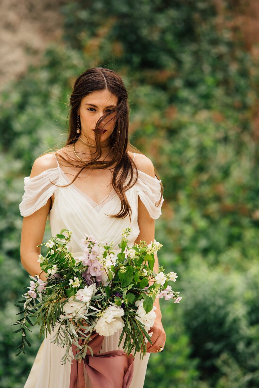 Nicole, White Willow portraits story frame 6: Nicole in a White Willow Photography-designed bridal editorial near Salmon Arm, moving from rock-face portraits through bouquet, veil and flower-crown details.