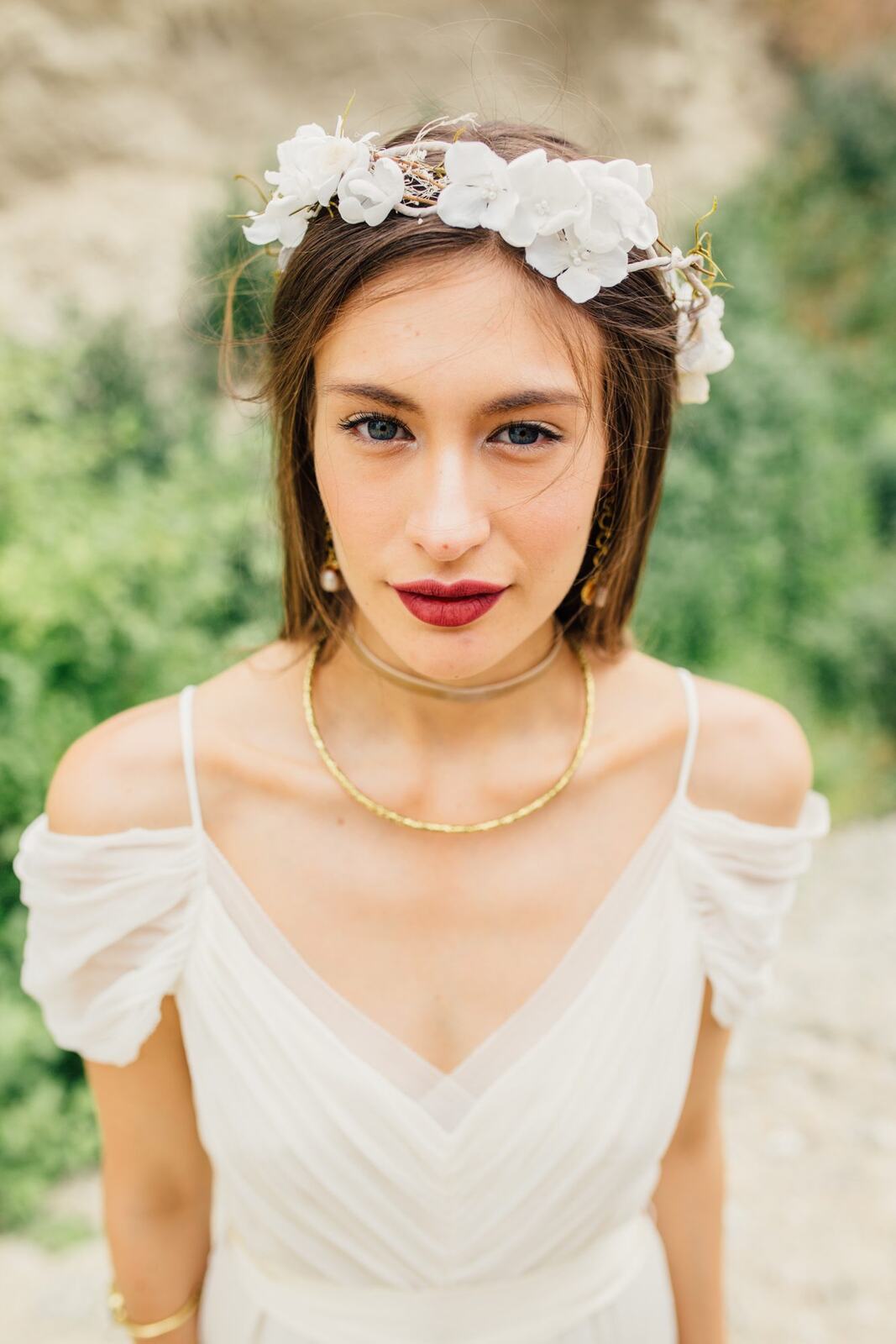 Nicole, White Willow portraits story frame 9: Nicole in a White Willow Photography-designed bridal editorial near Salmon Arm, moving from rock-face portraits through bouquet, veil and flower-crown details.