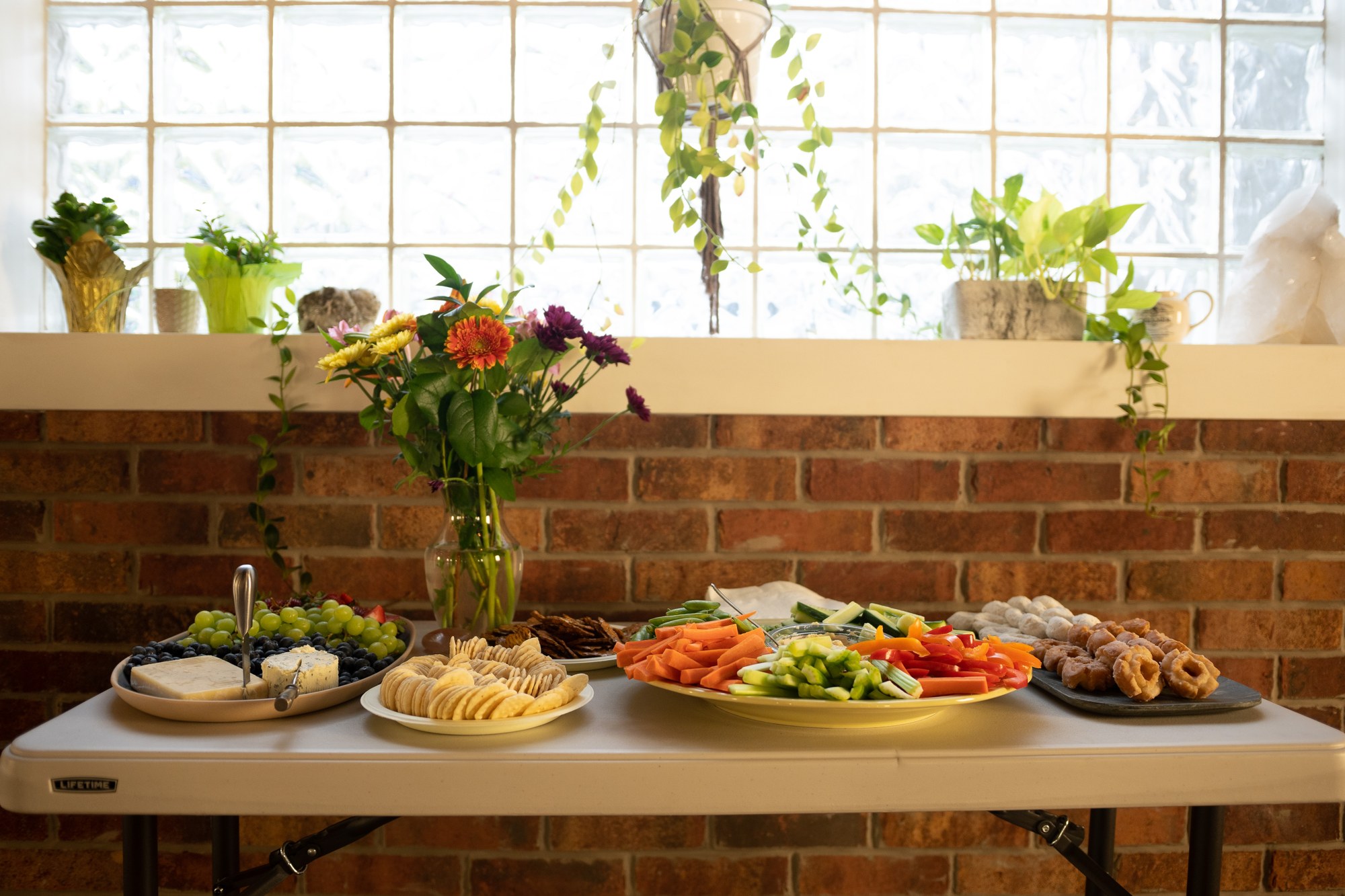Our Yoga Space Turns Three: The welcoming food table beneath the studio windows.