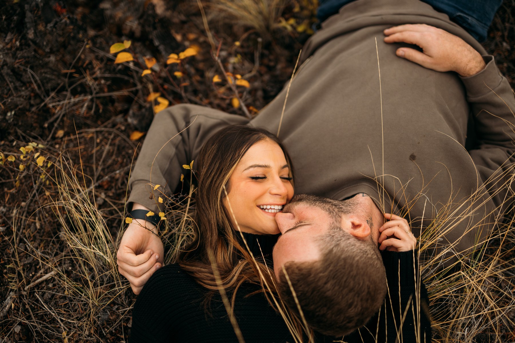 Rachel and Ryan portraits story frame 4: Okanagan couples portraits with dirt bikes, lake and mountain views, autumn sun, standing portraits and champagne celebration.