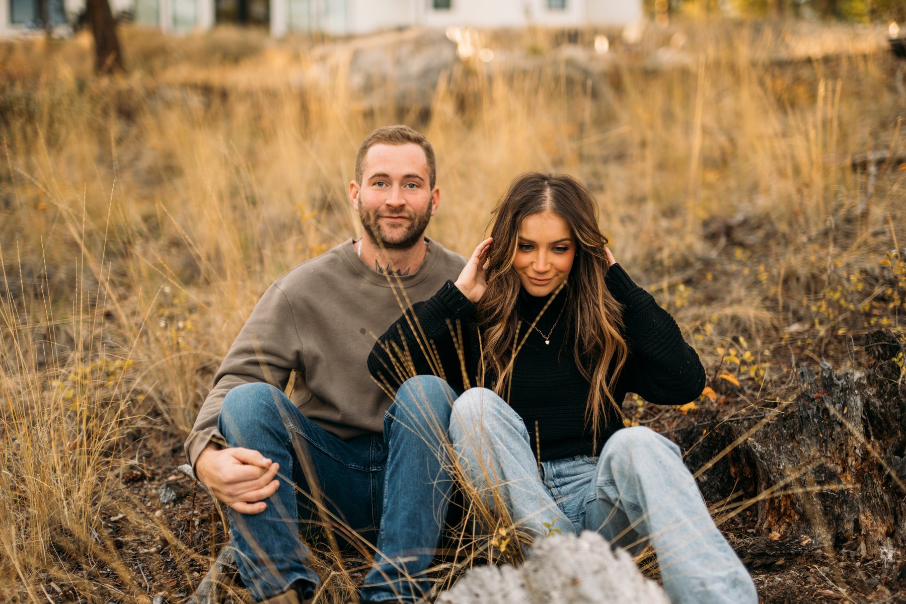 Rachel and Ryan portraits story frame 6: Okanagan couples portraits with dirt bikes, lake and mountain views, autumn sun, standing portraits and champagne celebration.