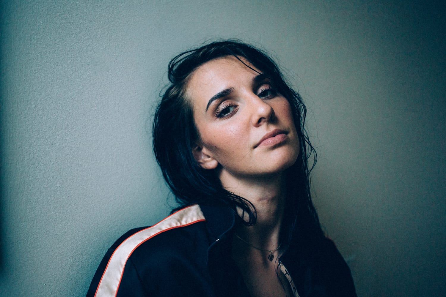 Rebecca in Smoke portraits story frame 14: A dark Kelowna portrait story for Rebecca with window light, smoke, denim, close expression and a low-key editorial mood.
