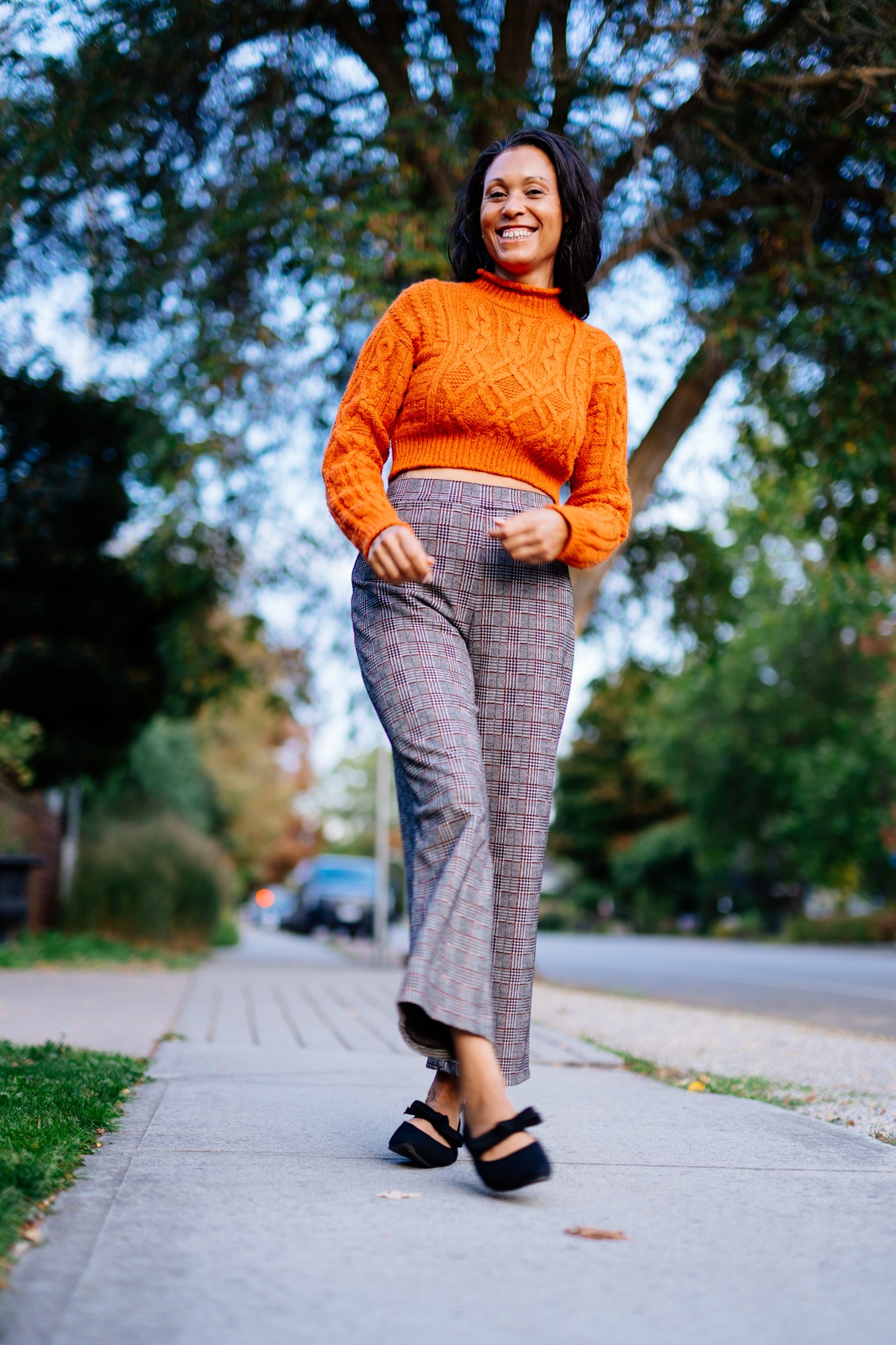 Rebekah in Autumn: Low-angle full figure on the leafy sidewalk.