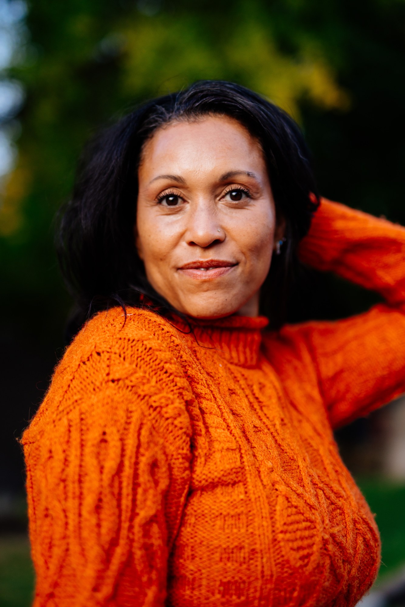 Rebekah in Autumn: Close calm gaze and orange-knit texture.