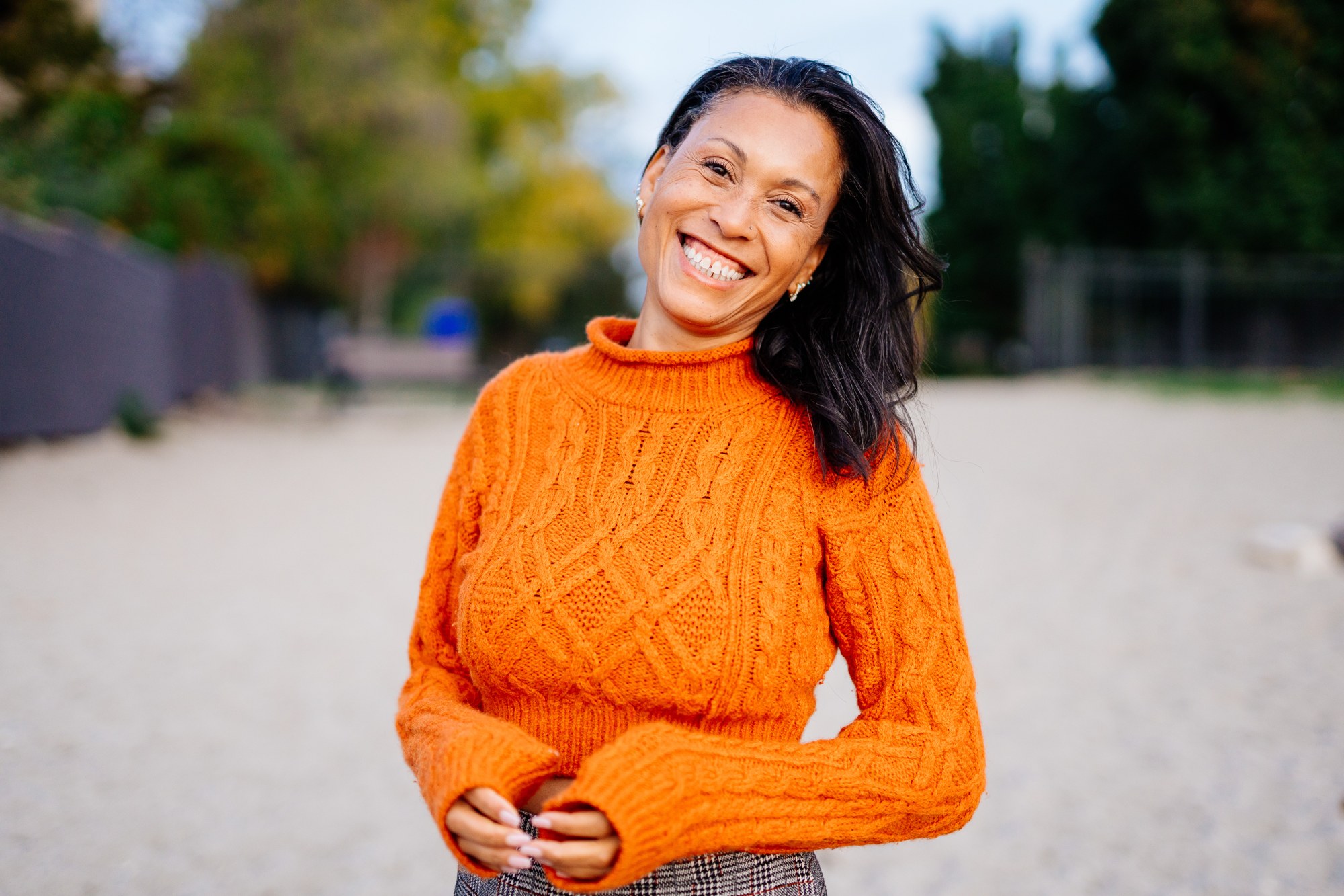 Rebekah in Autumn: Genuine tilted-head laugh in wider framing.