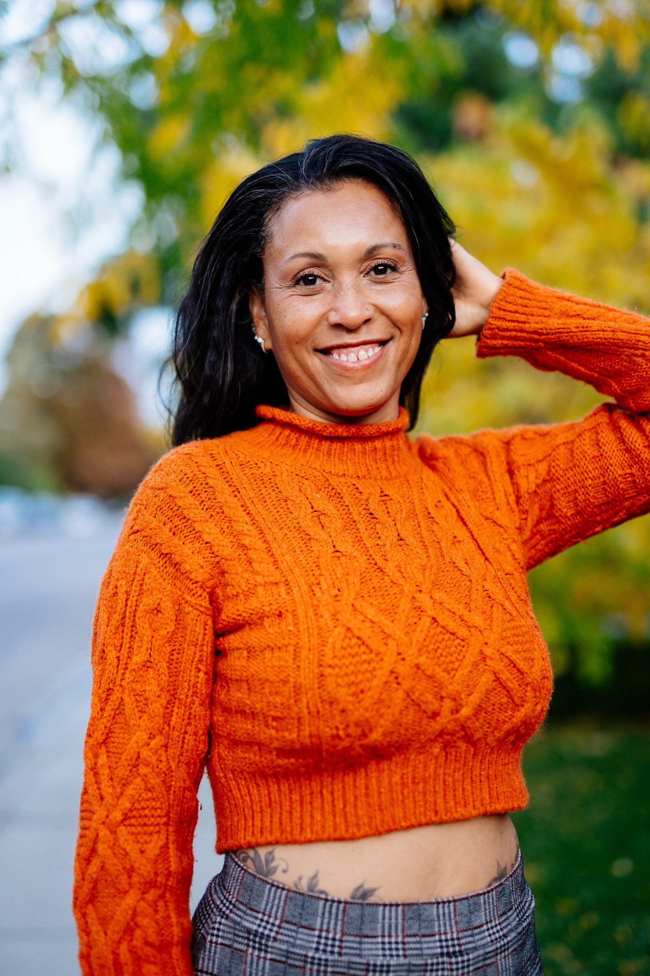Rebekah in Autumn: Warm smiling portrait against yellow foliage.