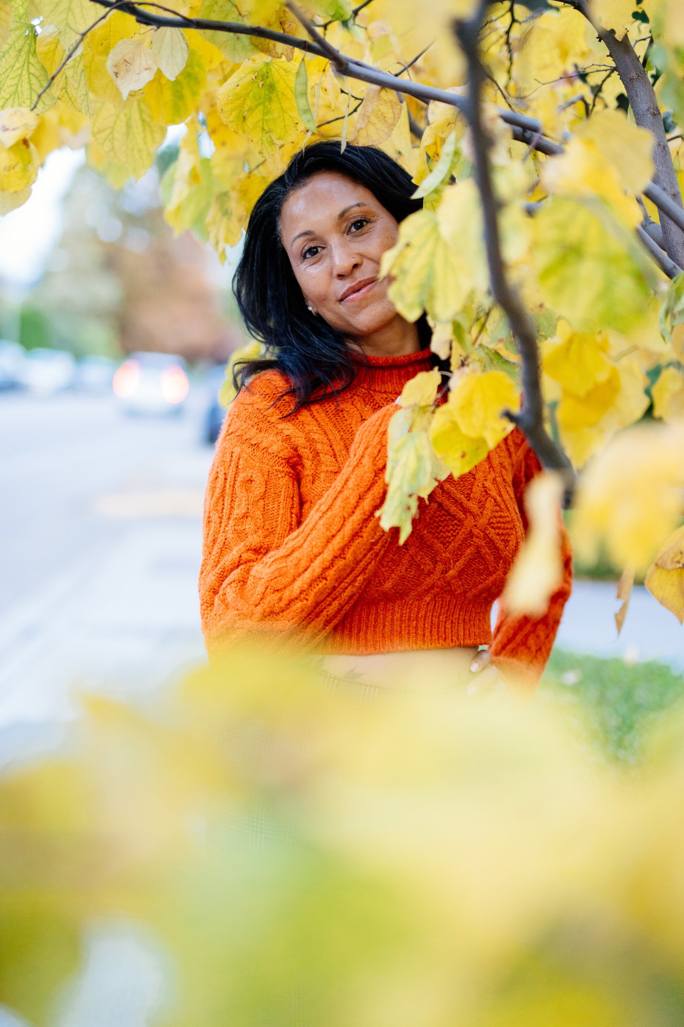 Rebekah in Autumn: Foreground leaves giving depth without hiding the face.