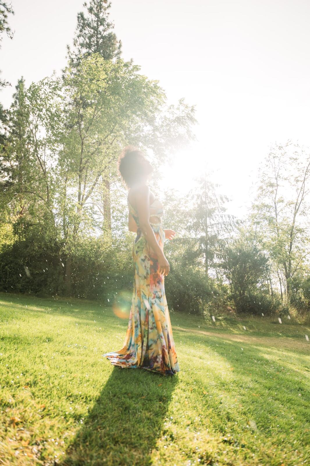 Rebekah at Bertram portraits story frame 1: A Bertram portrait story moving from floral dress and lake light into black dress, white shirt, sunset and water silhouettes.