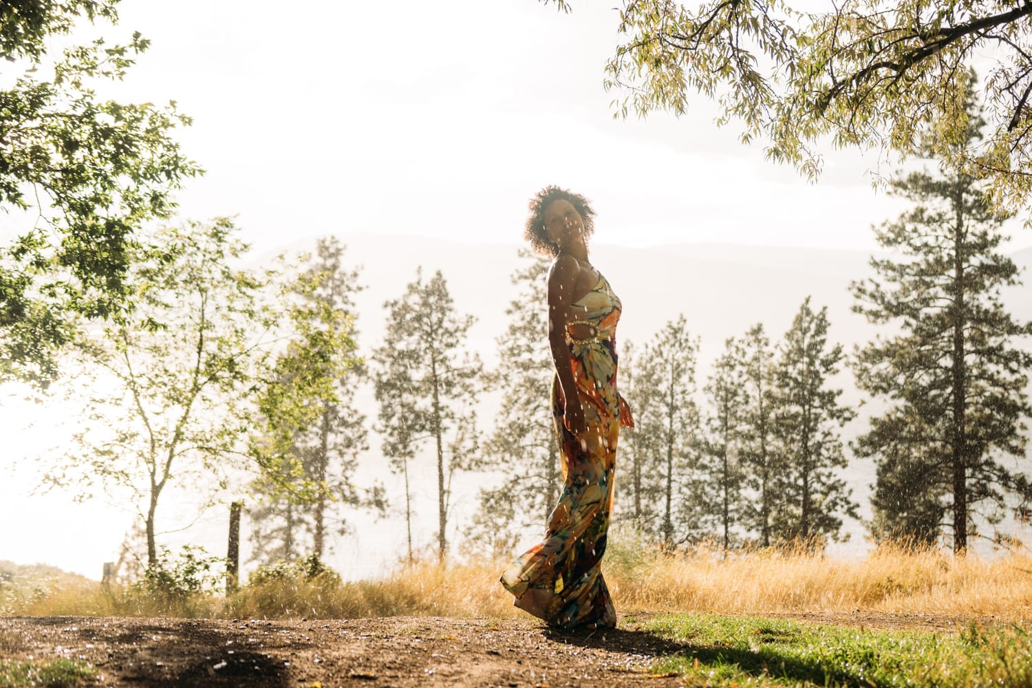Rebekah at Bertram portraits story frame 2: A Bertram portrait story moving from floral dress and lake light into black dress, white shirt, sunset and water silhouettes..