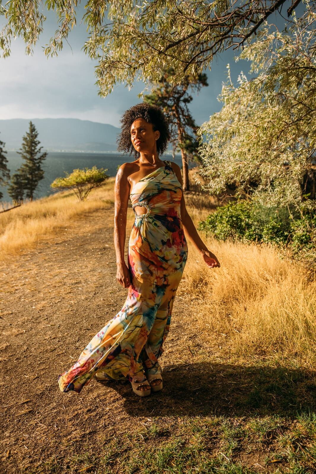 Rebekah at Bertram portraits story frame 2: A Bertram portrait story moving from floral dress and lake light into black dress, white shirt, sunset and water silhouettes.