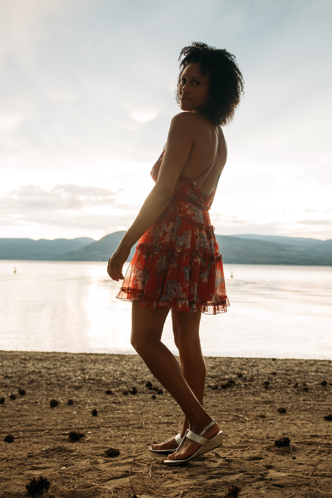 Rebekah at Bertram portraits story frame 12: A Bertram portrait story moving from floral dress and lake light into black dress, white shirt, sunset and water silhouettes..