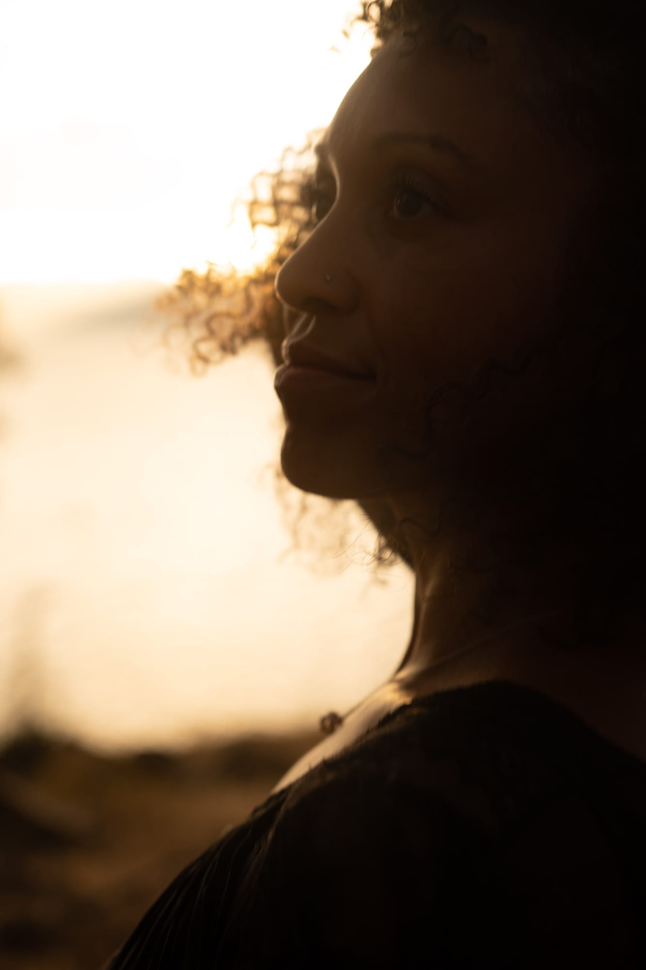 Rebekah at Bertram portraits story frame 15: A Bertram portrait story moving from floral dress and lake light into black dress, white shirt, sunset and water silhouettes..