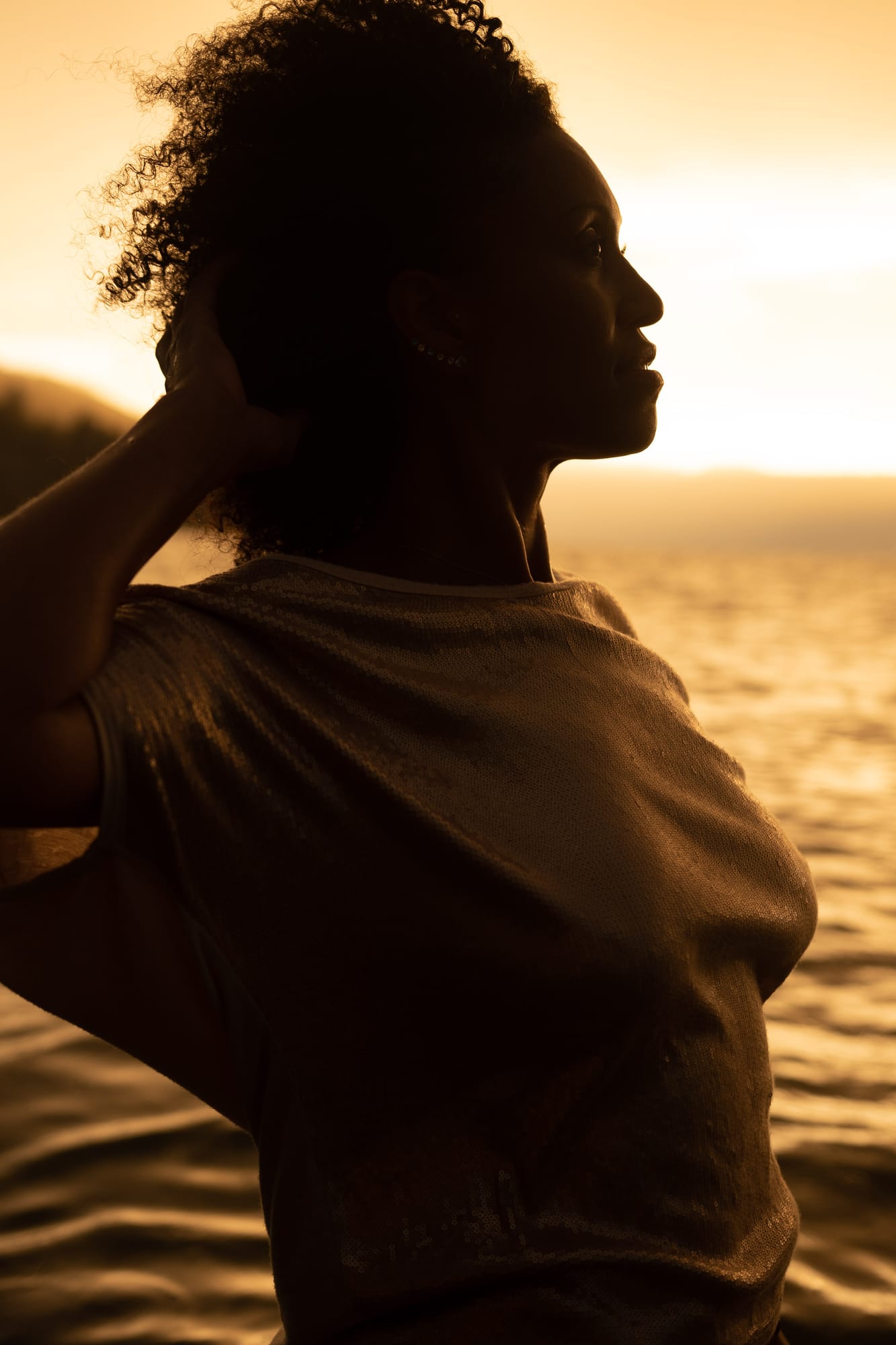 Rebekah at Bertram portraits story frame 16: A Bertram portrait story moving from floral dress and lake light into black dress, white shirt, sunset and water silhouettes..