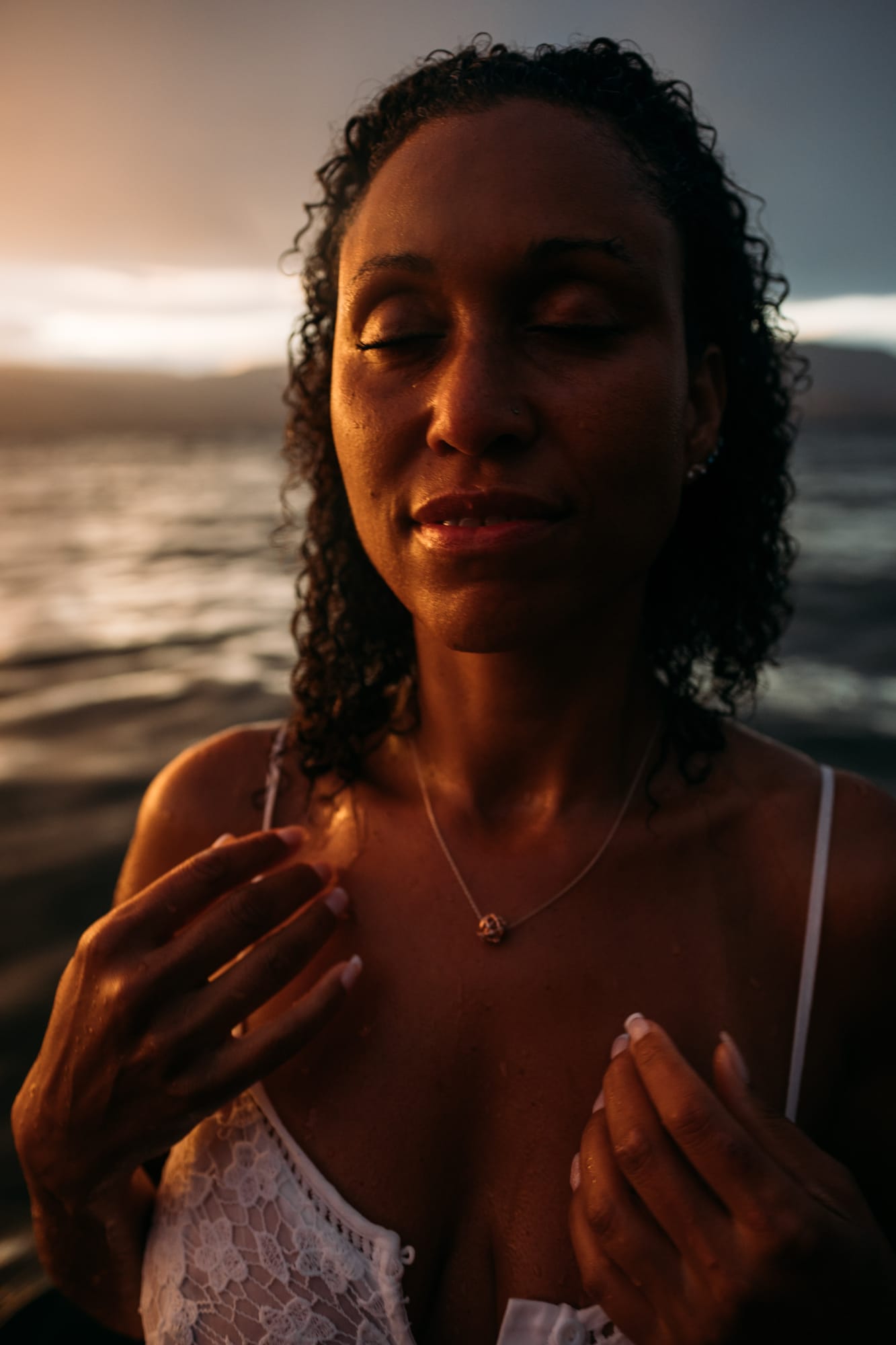 Rebekah at Bertram portraits story frame 20: A Bertram portrait story moving from floral dress and lake light into black dress, white shirt, sunset and water silhouettes..