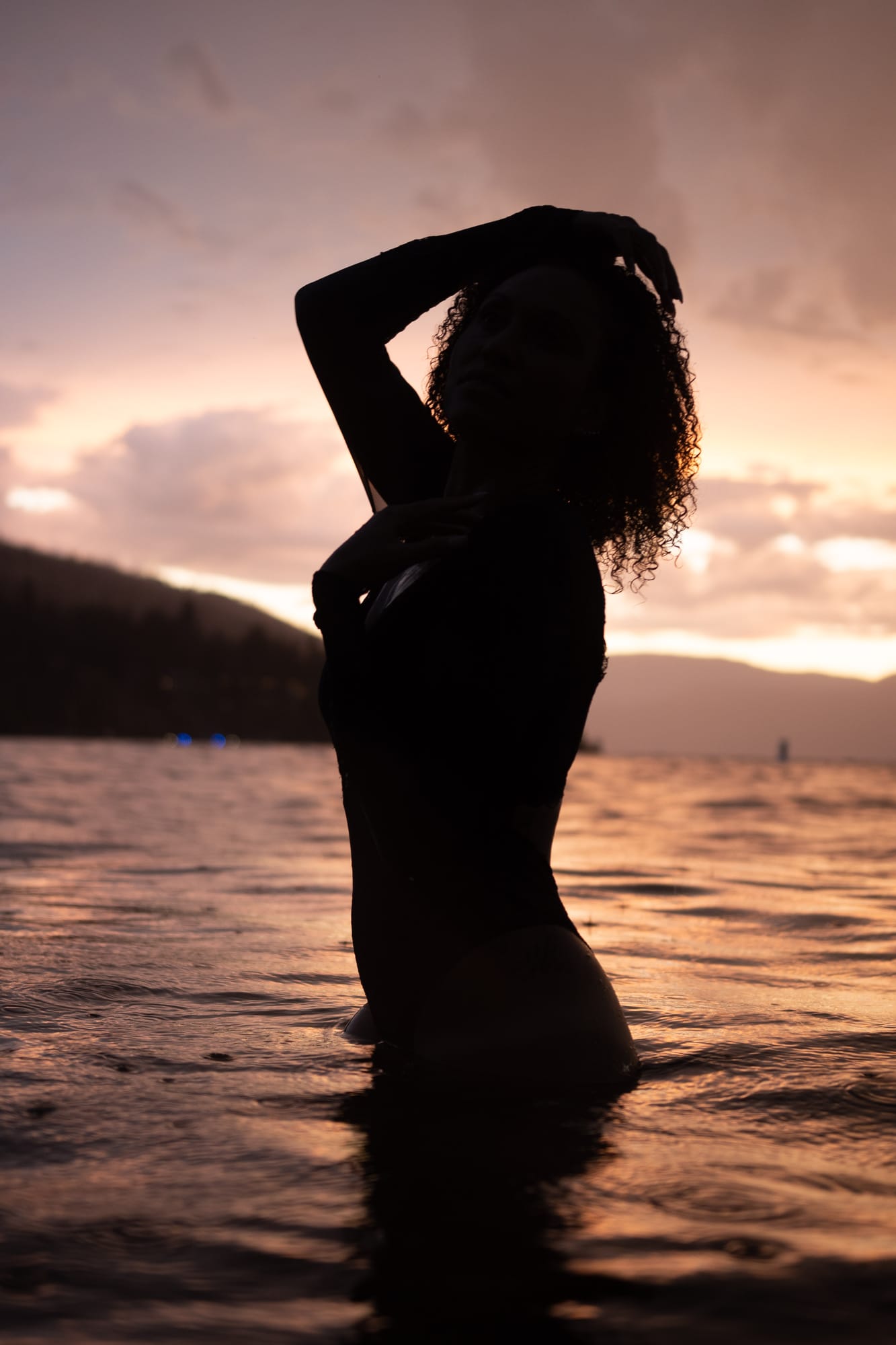 Rebekah at Bertram portraits story frame 22: A Bertram portrait story moving from floral dress and lake light into black dress, white shirt, sunset and water silhouettes..