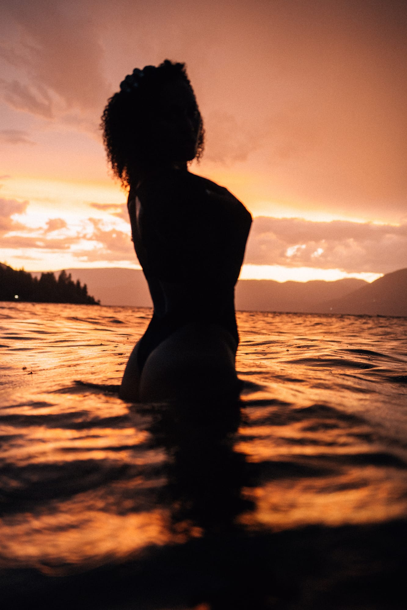 Rebekah at Bertram portraits story frame 23: A Bertram portrait story moving from floral dress and lake light into black dress, white shirt, sunset and water silhouettes..