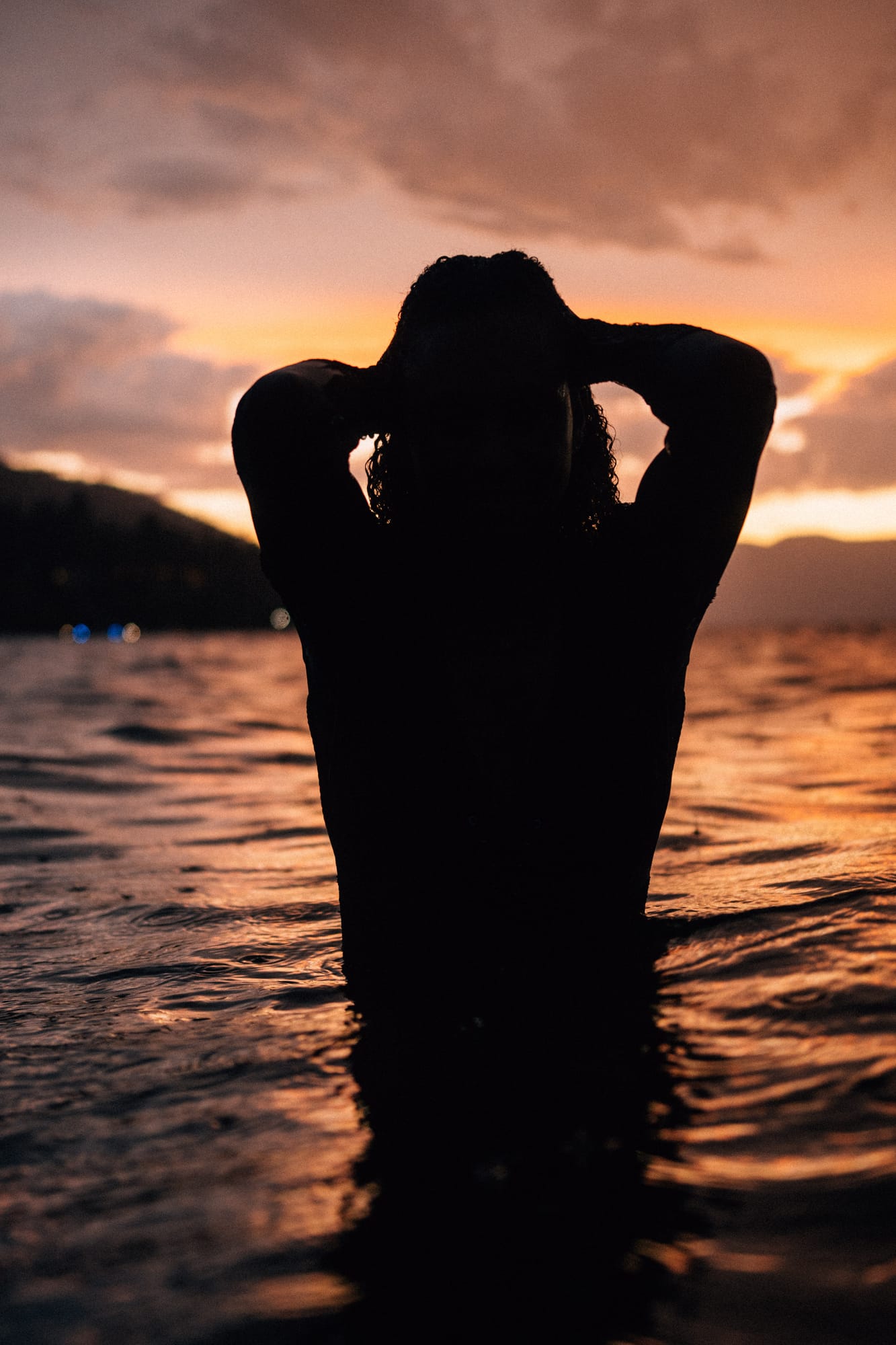Rebekah at Bertram portraits story frame 24: A Bertram portrait story moving from floral dress and lake light into black dress, white shirt, sunset and water silhouettes..
