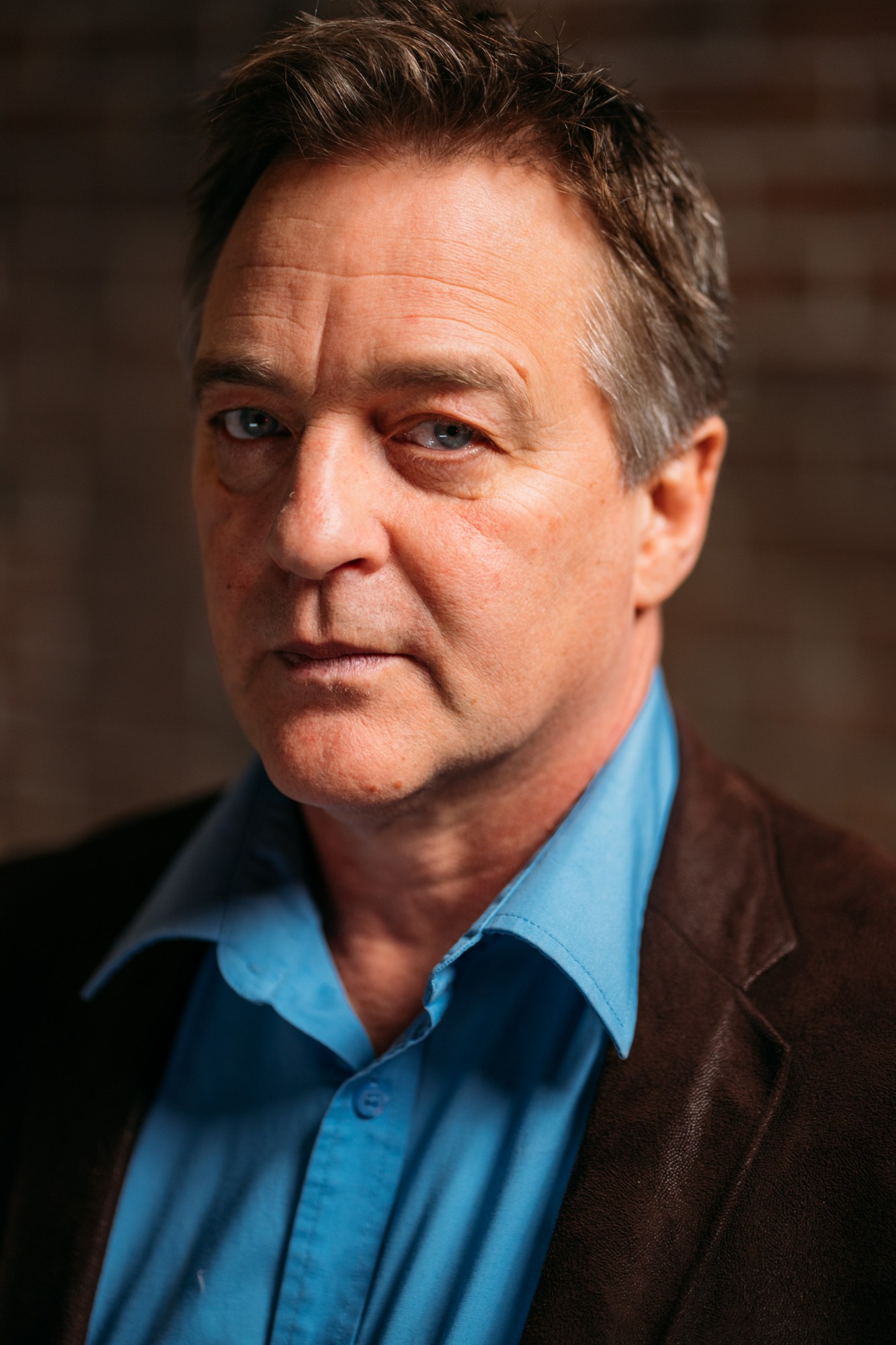 Close actor portrait of Roark with a serious expression