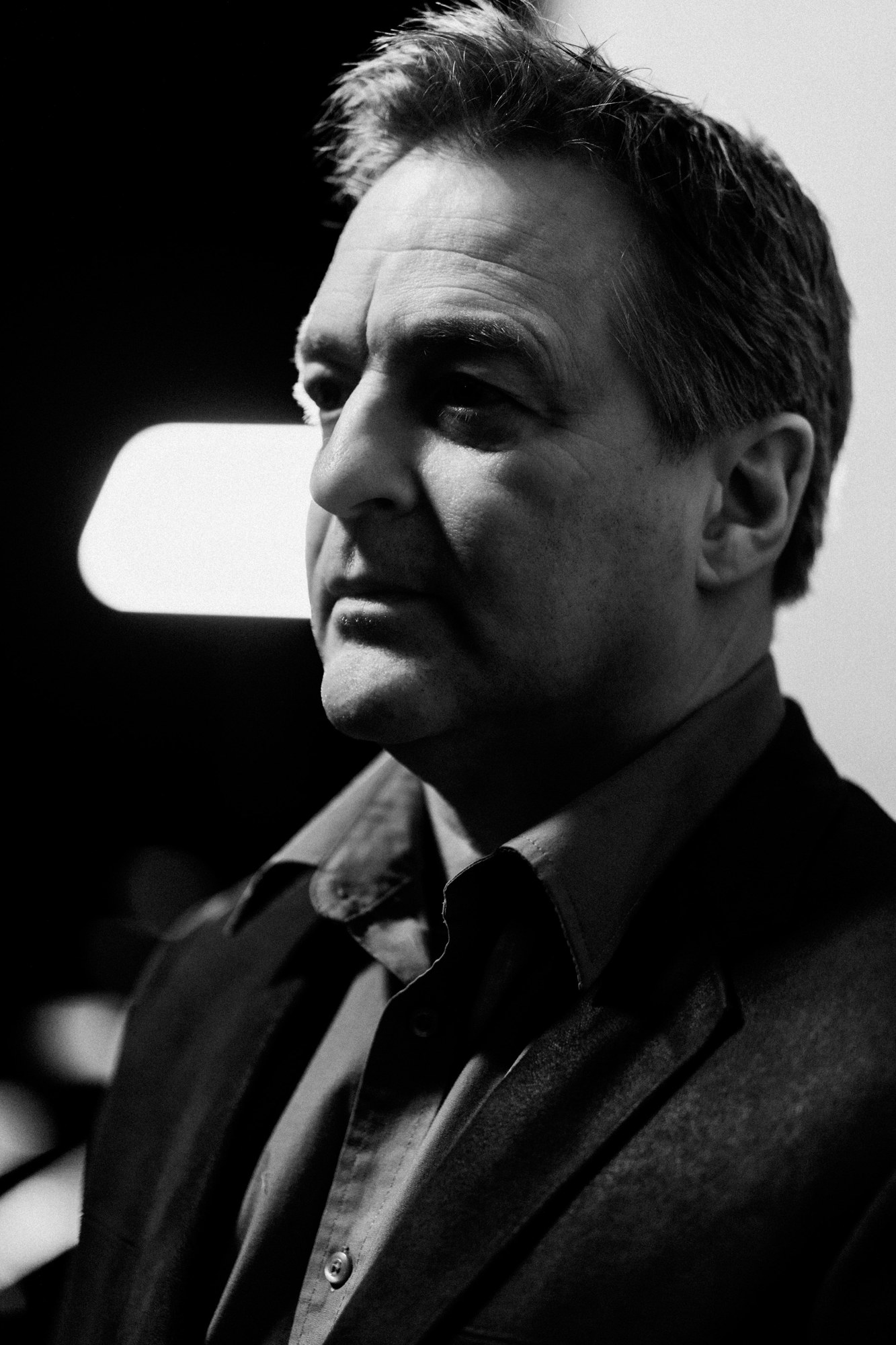 Black-and-white close portrait of Roark looking into the camera