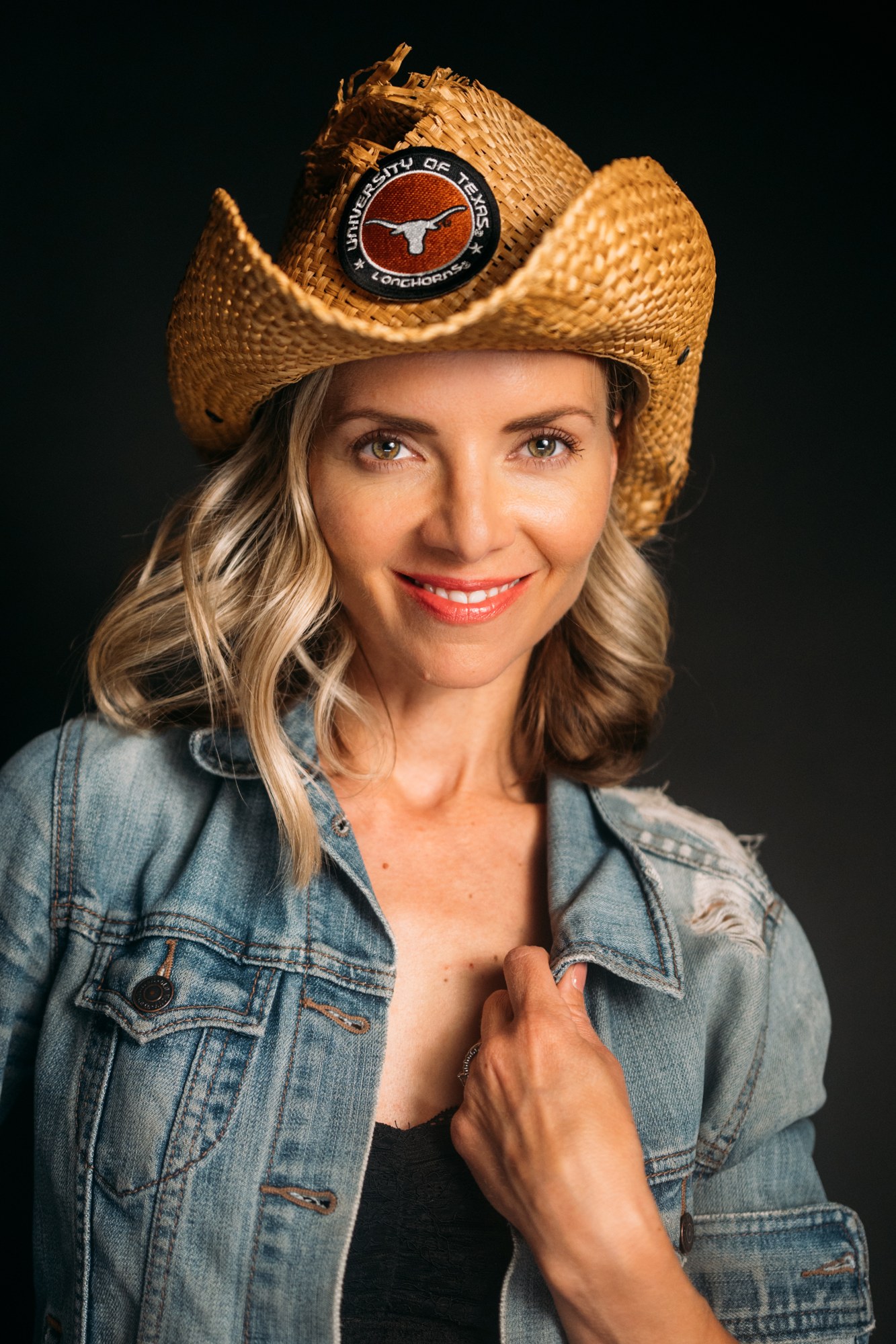 Sarah smiling beneath a cowboy hat