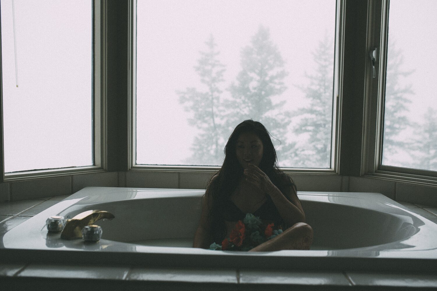 Sarah: Henna, Snow and Candlelight portraits story frame 20: A four-part portrait story with Sarah in Kelowna, moving from a living-room henna session into snow, a daylight coconut-milk bath and a candlelit bath.