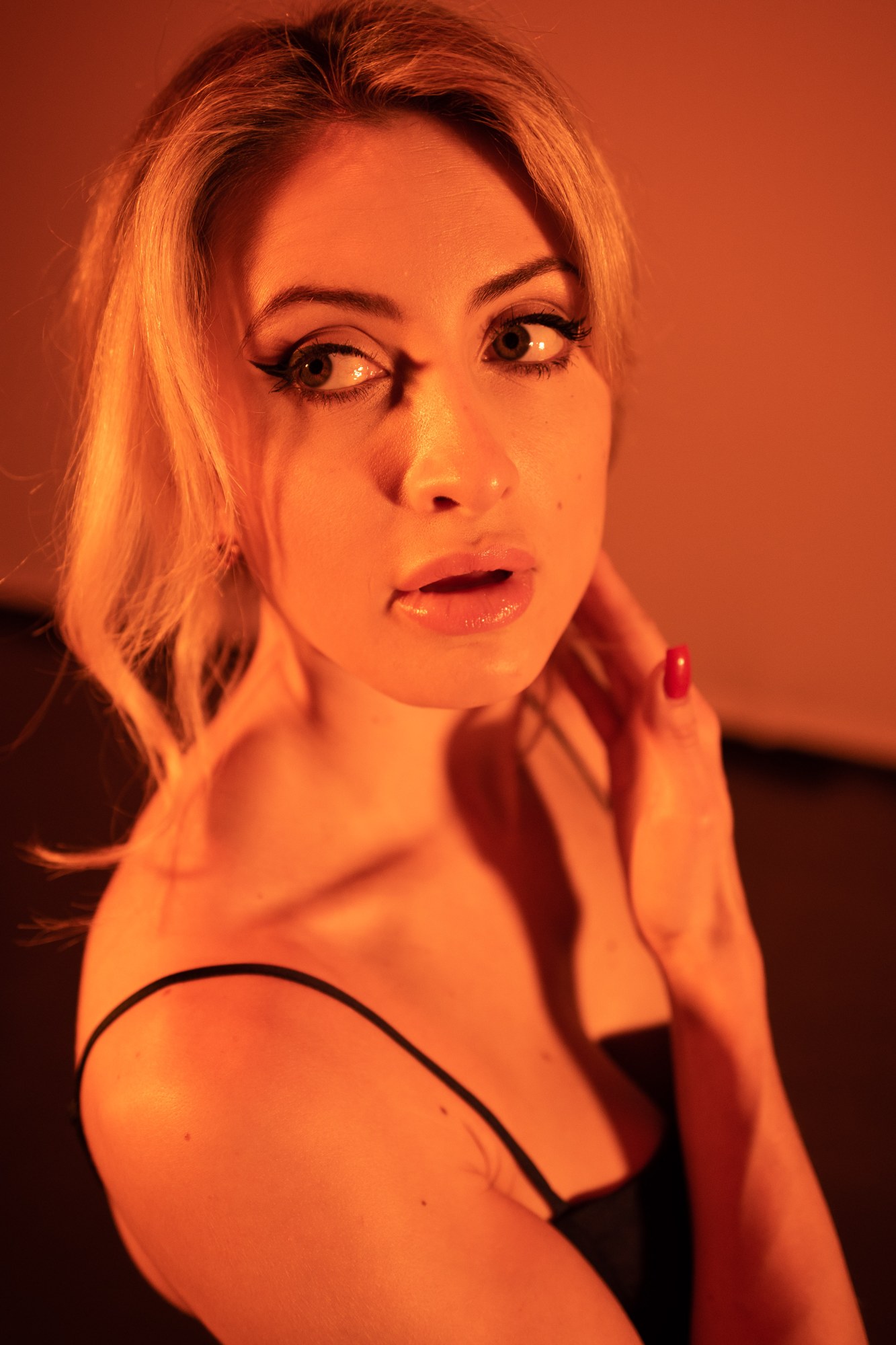 Shanelle looking back over her shoulder in warm orange light